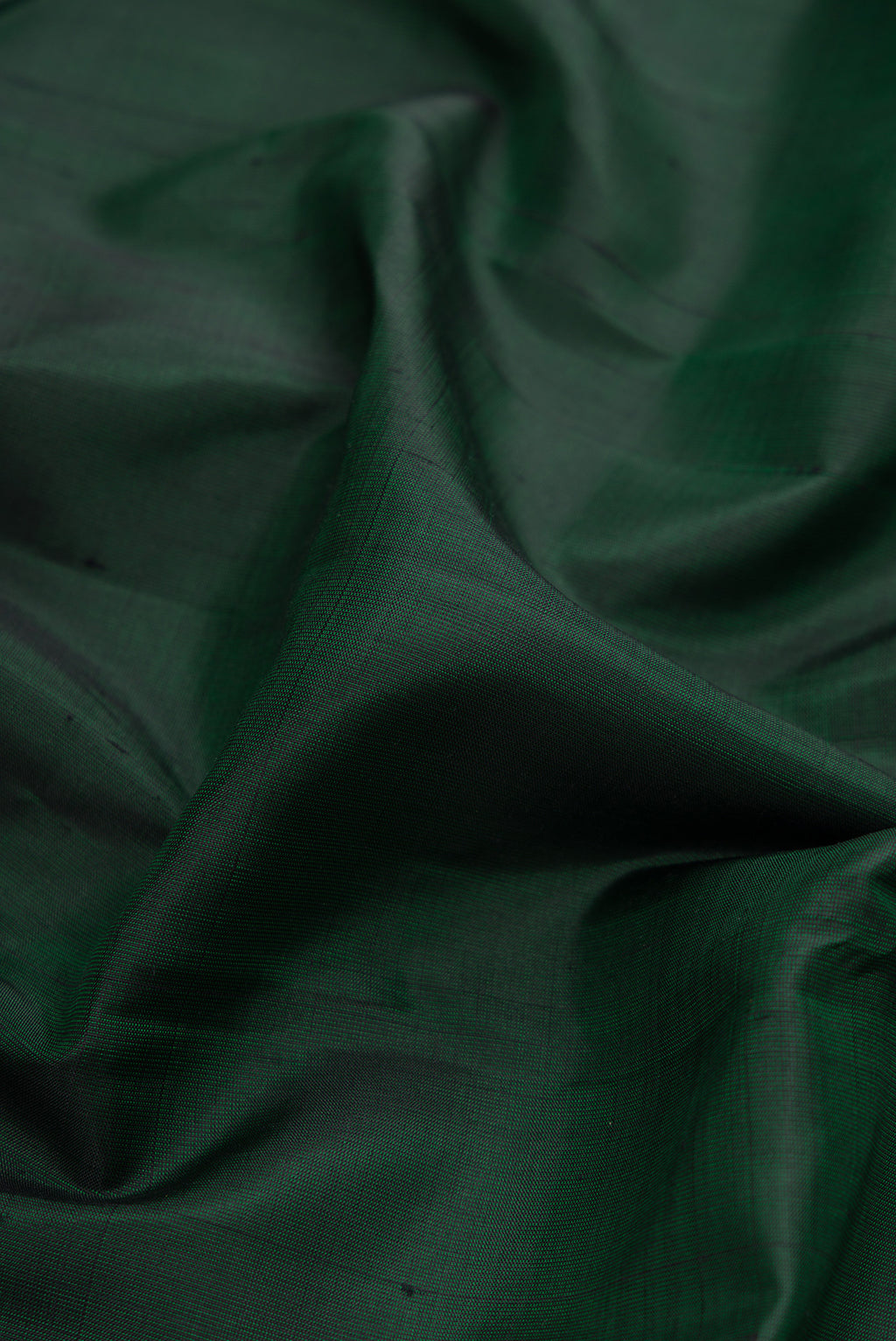 Close up of Bottle Green Dual Tone Kanjivaram Silk Saree with Plain Body and Zari Border.  displaying folds