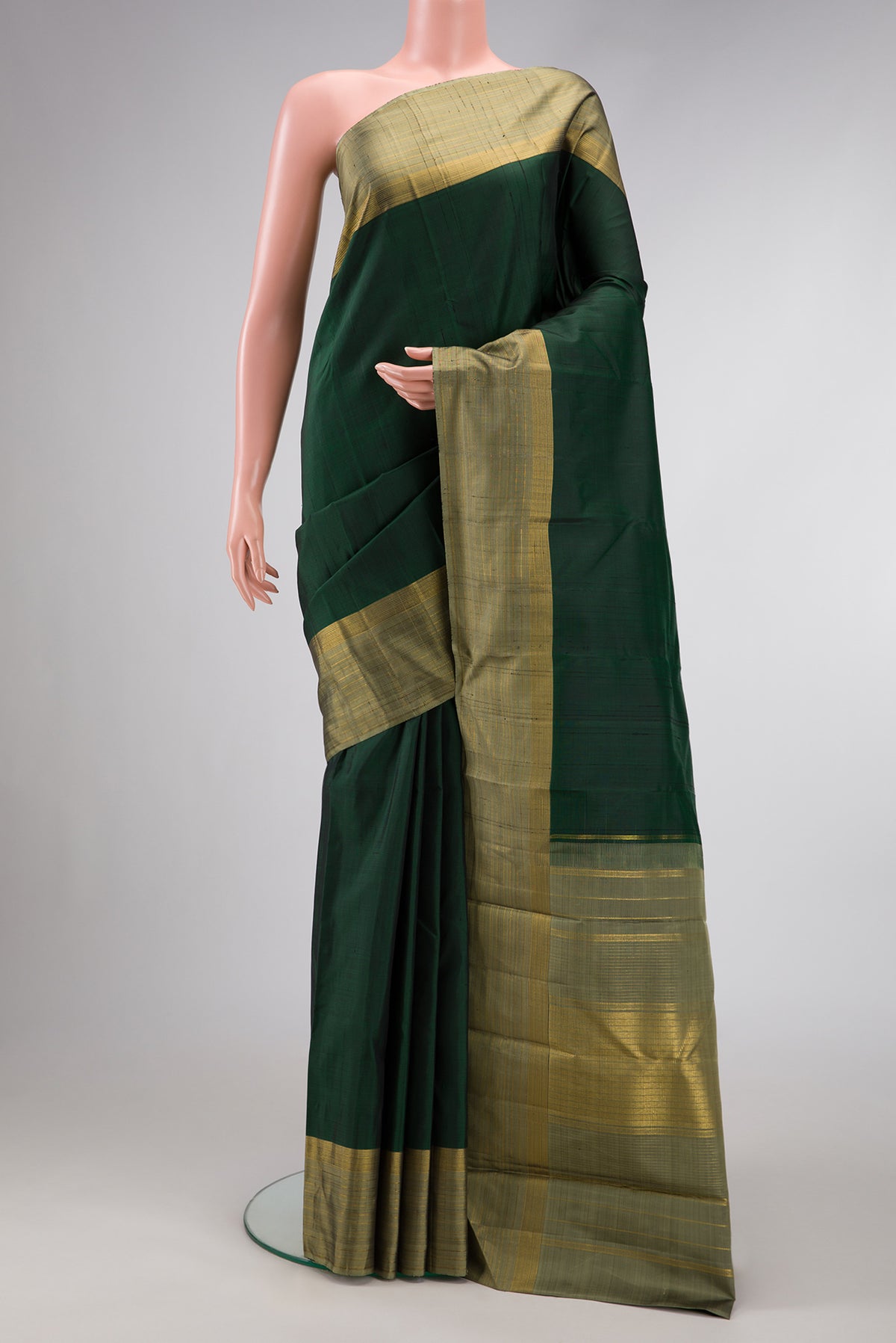 Bottle Green Dual Tone Kanjivaram Silk Saree with Plain Body and Zari Border.  displayed on a mannequin