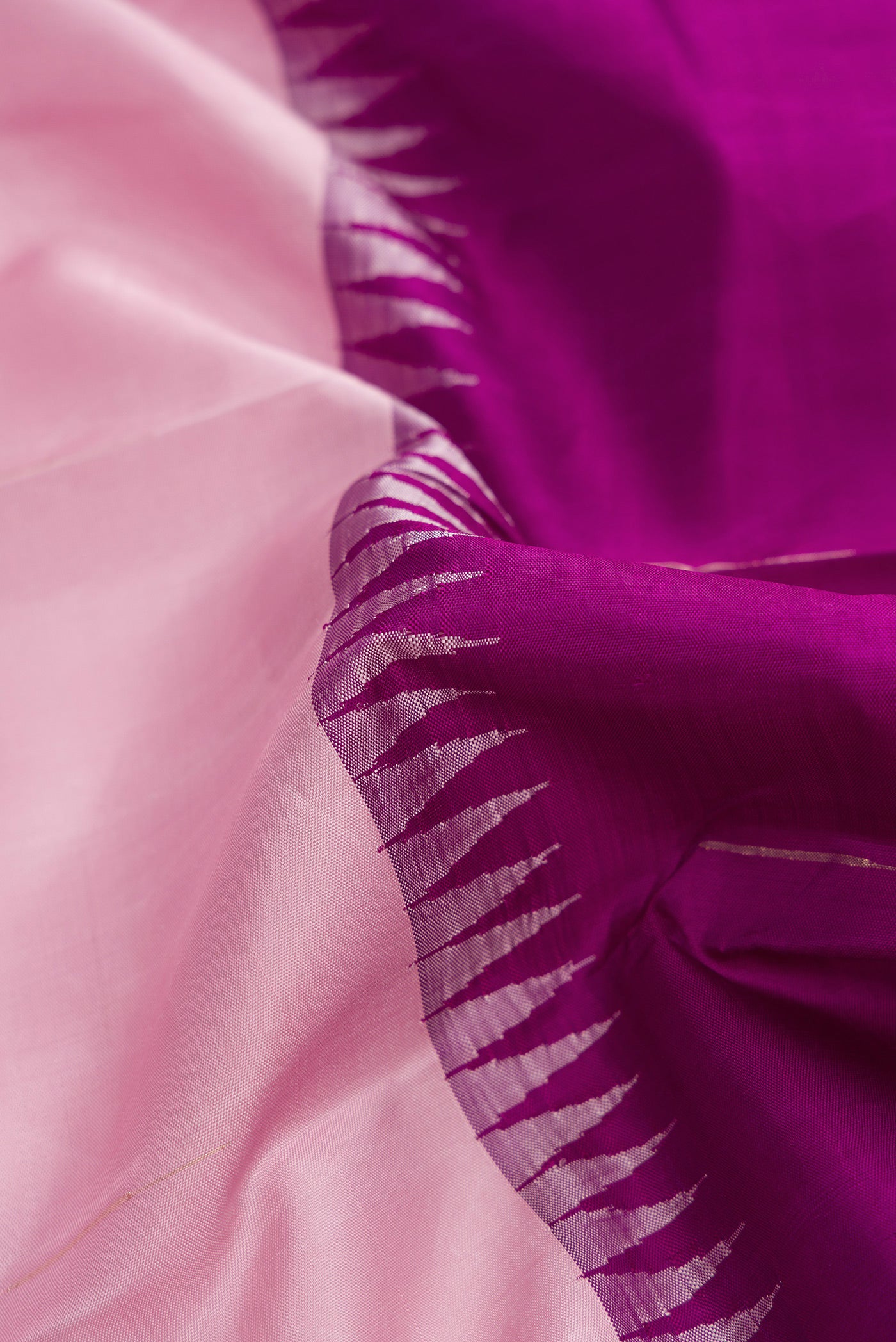 Close up of Pink and Purple Color Kanjivaram Silk Saree with Half And Half on the body and Without Border.  displaying folds