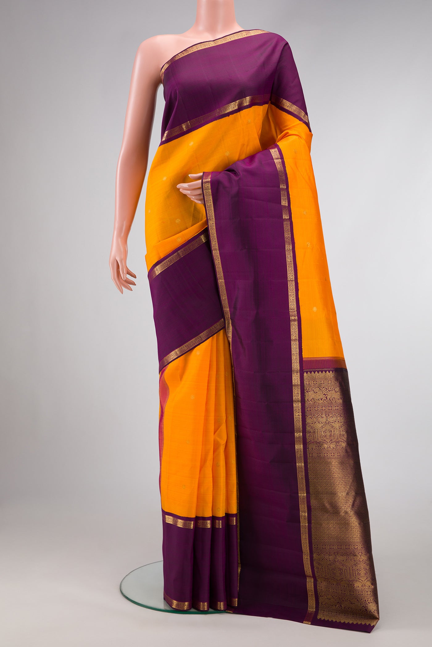 Mustard Dual Tone Kanjivaram Silk Saree with Zari Butta on the body and Zari Border.  displayed on a mannequin