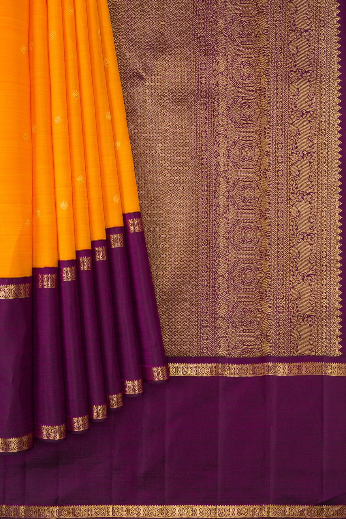 Pleats and pallu of Mustard Dual Tone Kanjivaram Silk Saree with Zari Butta on the body and Zari Border. 
