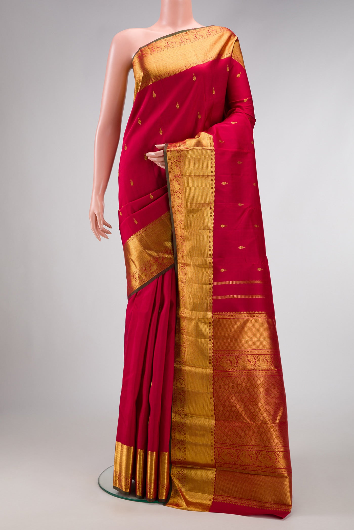 Red Dual Tone Kanjivaram Silk Saree with Zari Butta on the body and Zari Border.  displayed on a mannequin