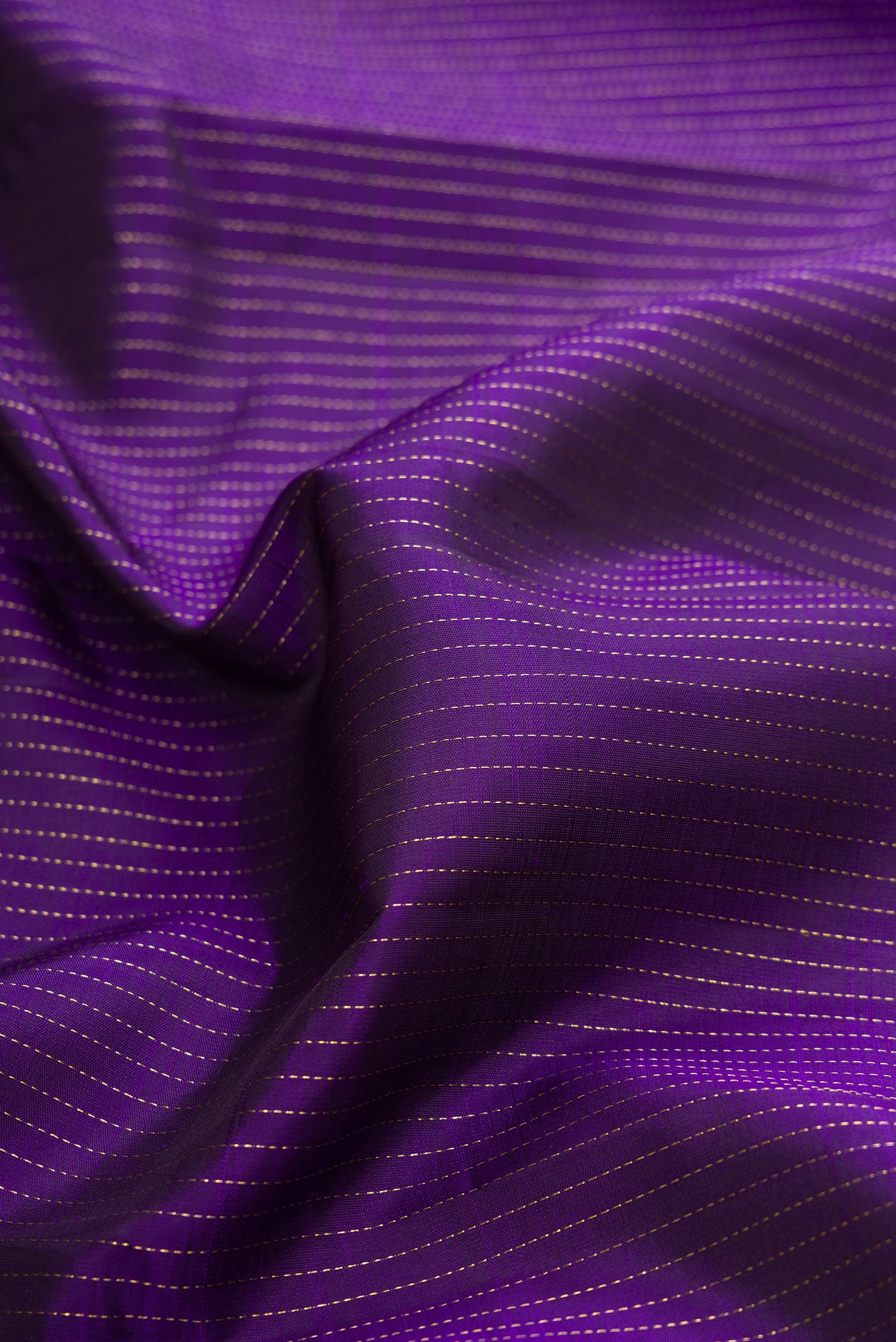 Close up of Violet Dual Tone Kanchipuram Silk Saree with Stripes on the body and Zari Border.  displaying folds