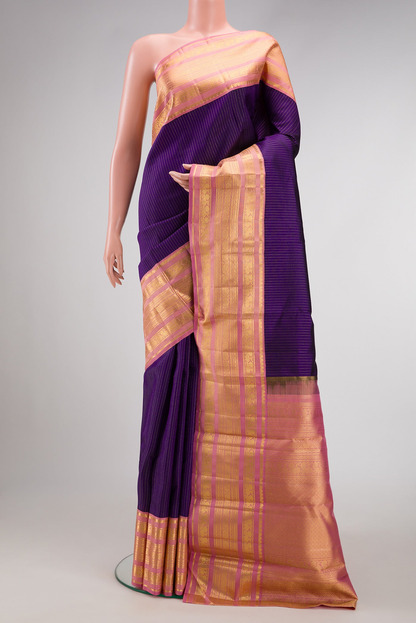 Violet Dual Tone Kanchipuram Silk Saree with Stripes on the body and Zari Border.  displayed on a mannequin
