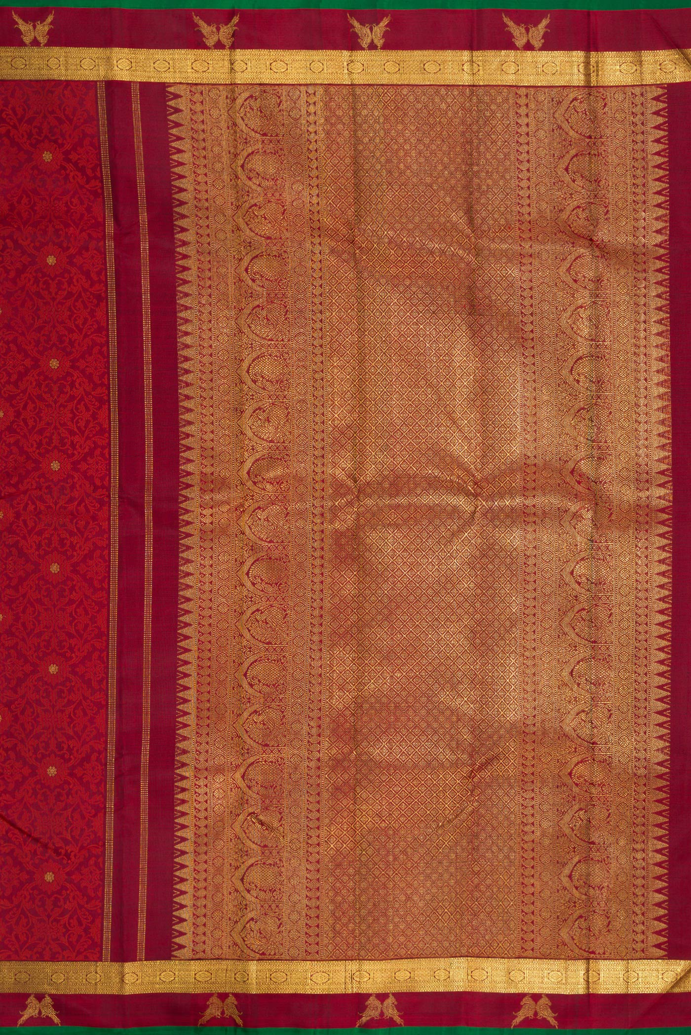 Close up image of the pallu of Maroon Dual Tone Kanchipuram Silk Saree with Jacquard With Zari Butta on the body and Zari Border. 