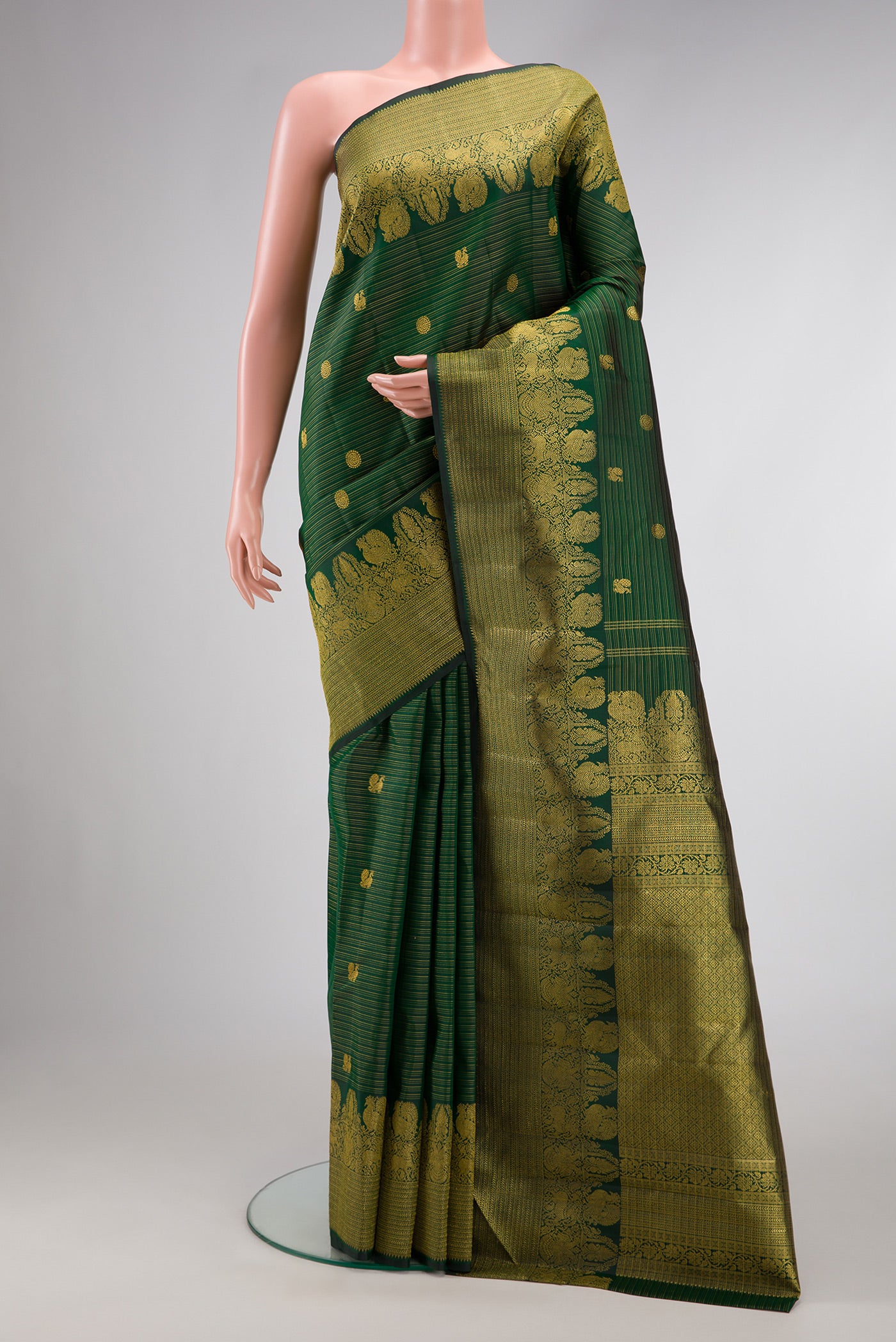 Green Dual Tone Kanchipuram Silk Saree with Zari Butta on the body and Zari Border.  displayed on a mannequin