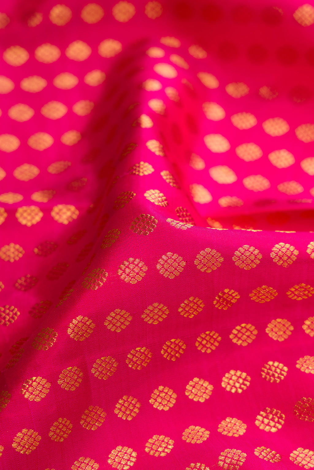 Close up of Pink Dual Tone Kanchipuram Silk Saree with Zari Butta on the body and Zari Border.  displaying folds