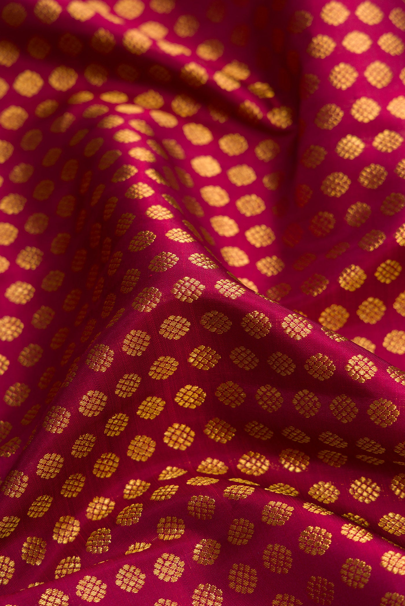 Close up of Maroon Dual Tone Kanchipuram Silk Saree with Zari Brocade on the body and Zari Border.  displaying folds