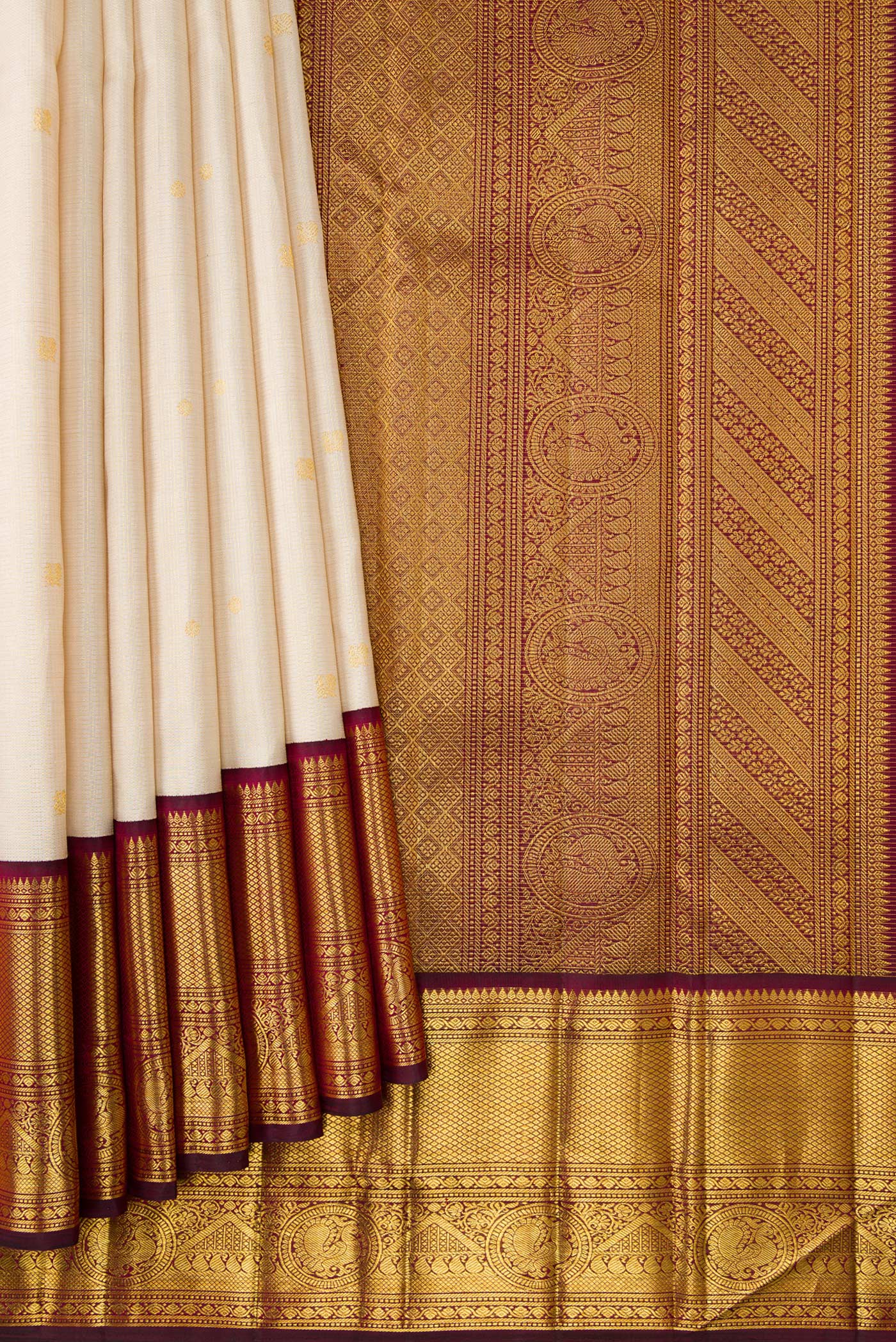 Pleats and pallu of Beige Dual Tone Kanchipuram Silk Saree with Zari Butta on the body and Zari Border. 