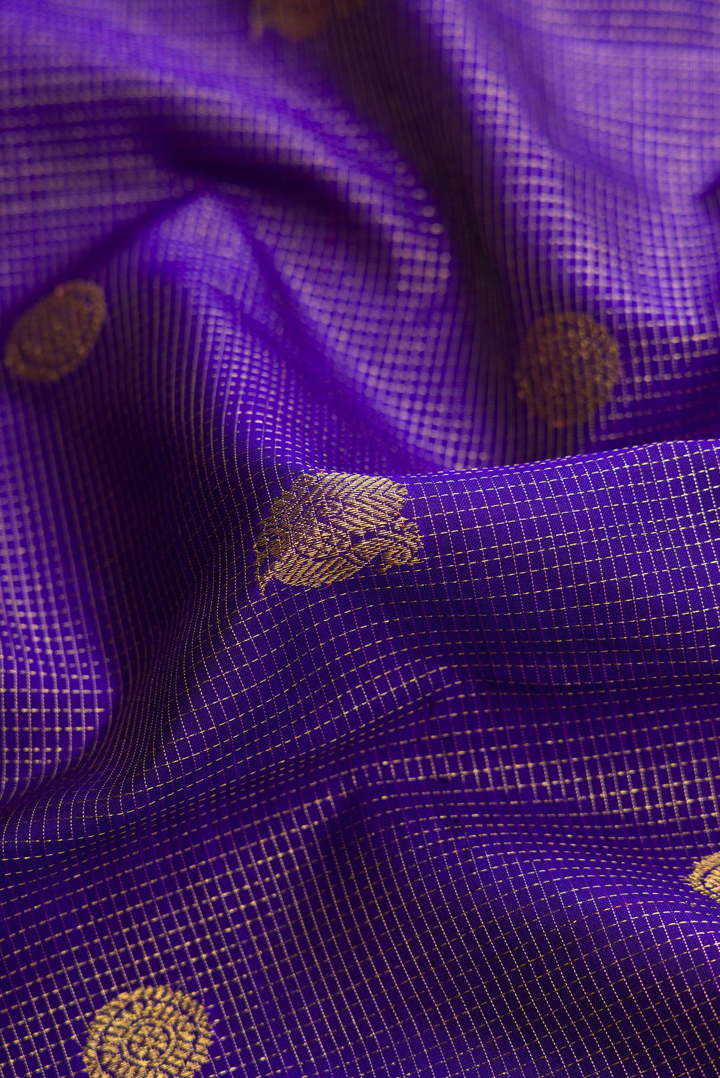 Close up of Royal Blue Dual Tone Kanchipuram Silk Saree with Checked design on the body and Zari Border.  displaying folds