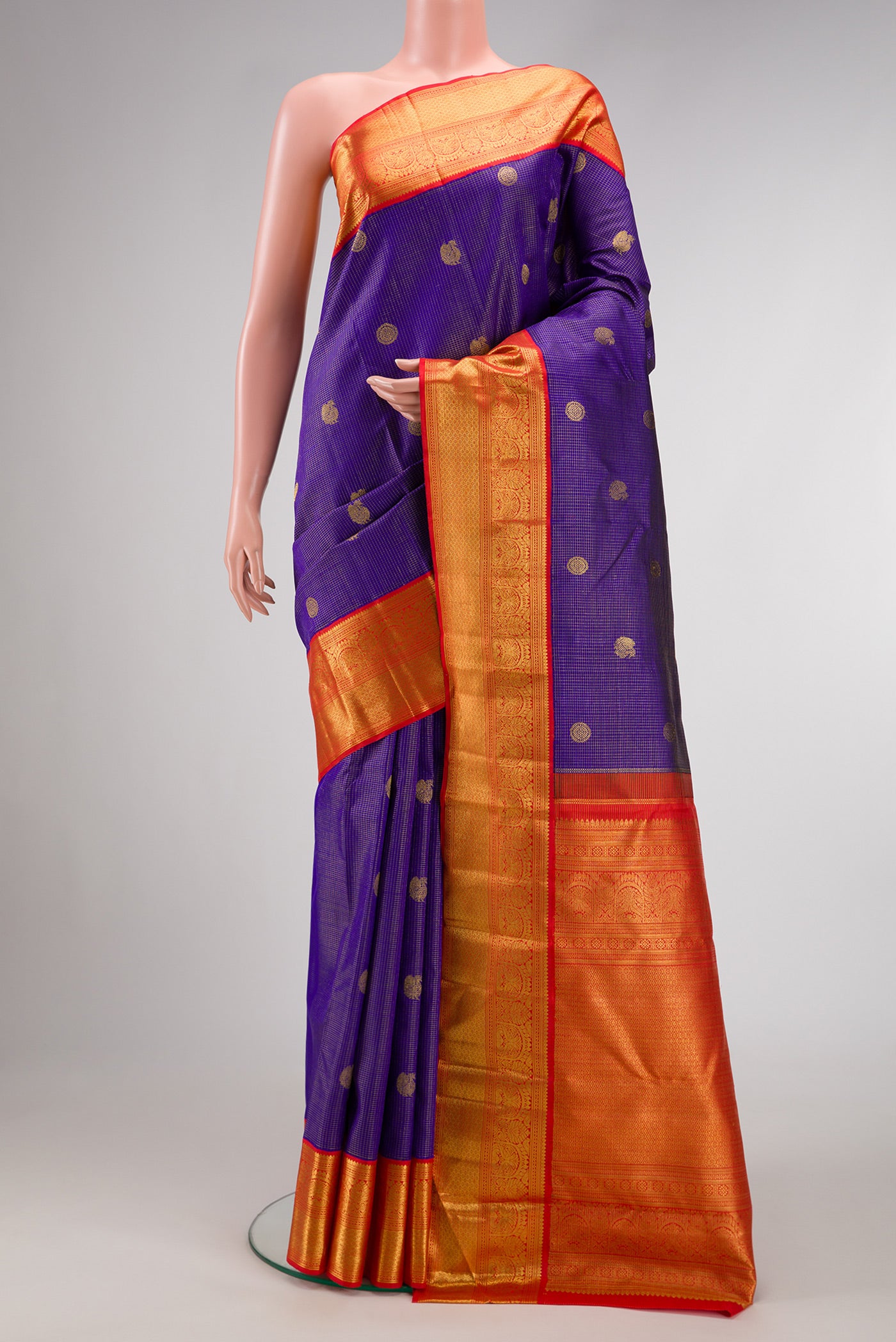 Royal Blue Dual Tone Kanchipuram Silk Saree with Checked design on the body and Zari Border.  displayed on a mannequin