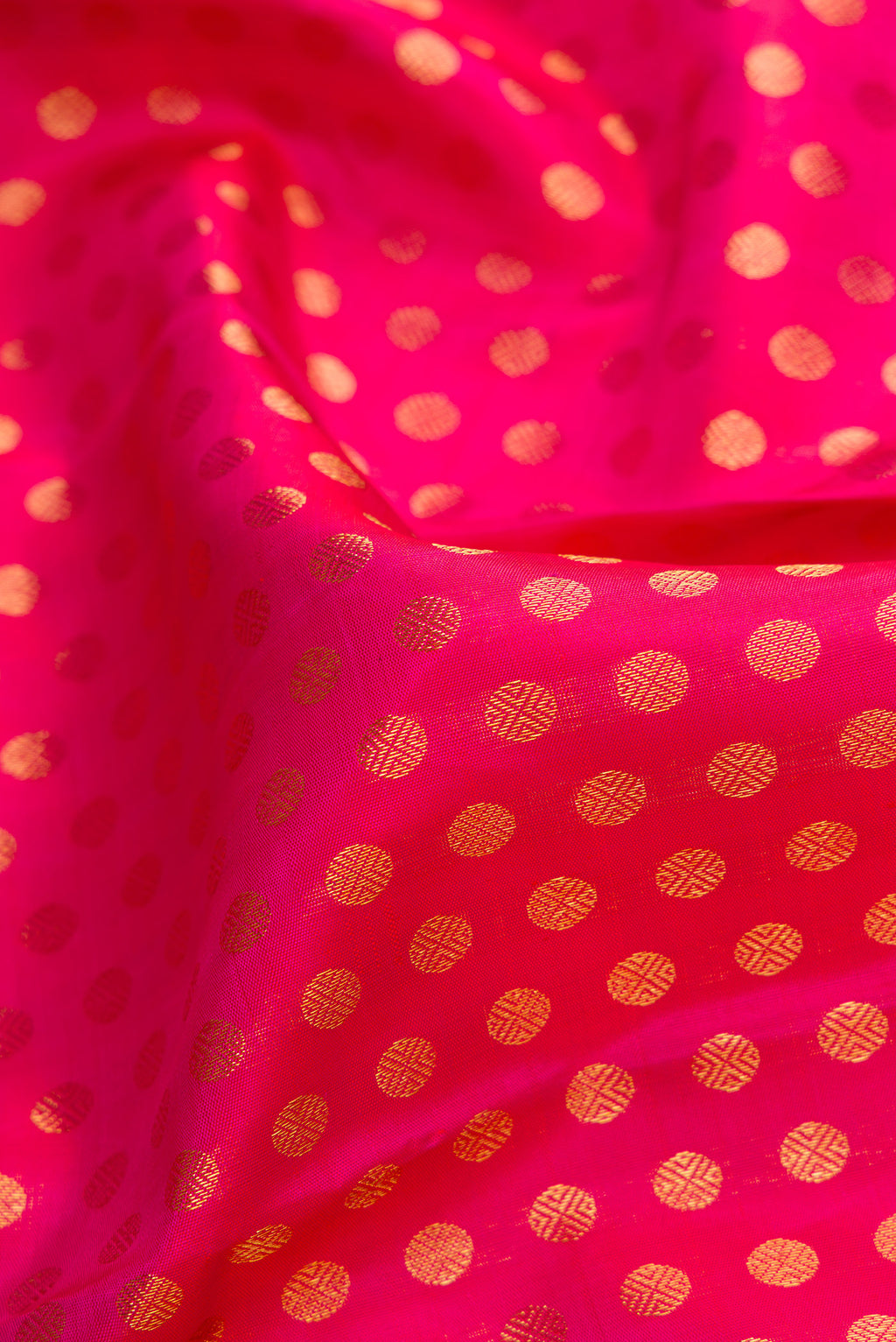 Close up of Pink Dual Tone Kanchipuram Silk Saree with Zari Butta on the body and Zari Border.  displaying folds