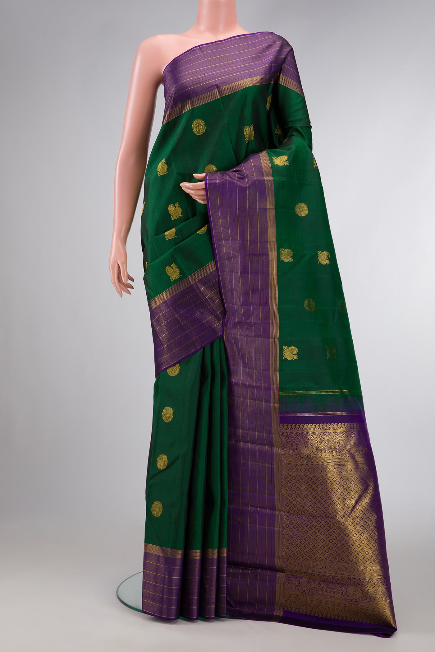 Green Dual Tone Kanjivaram Silk Saree with Zari Butta on the body and Zari Border.  displayed on a mannequin