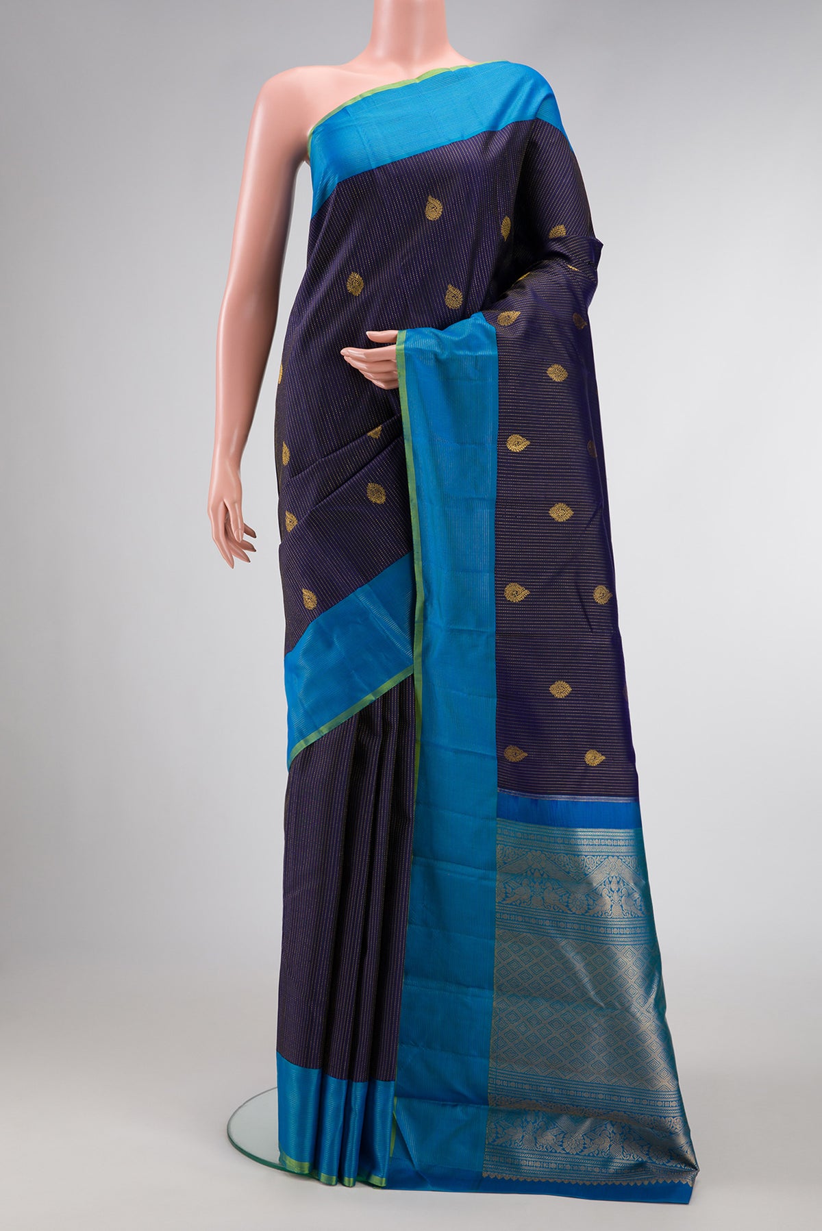Navy Blue Dual Tone Kanjivaram Silk Saree with Zari Butta on the body and Zari Border.  displayed on a mannequin
