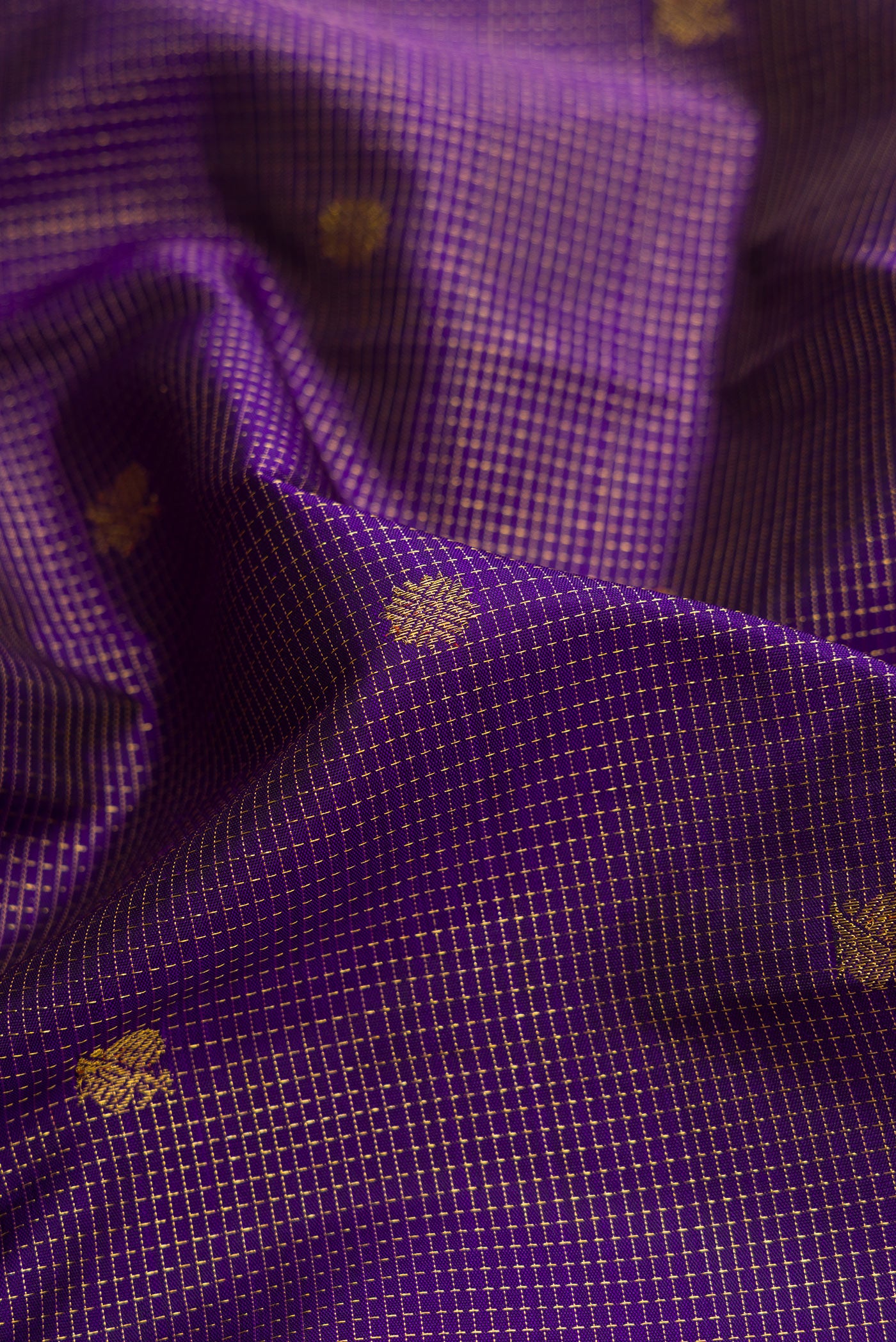 Close up of Violet Dual Tone Kanchipuram Silk Saree with Zari Butta on the body and Zari Border.  displaying folds