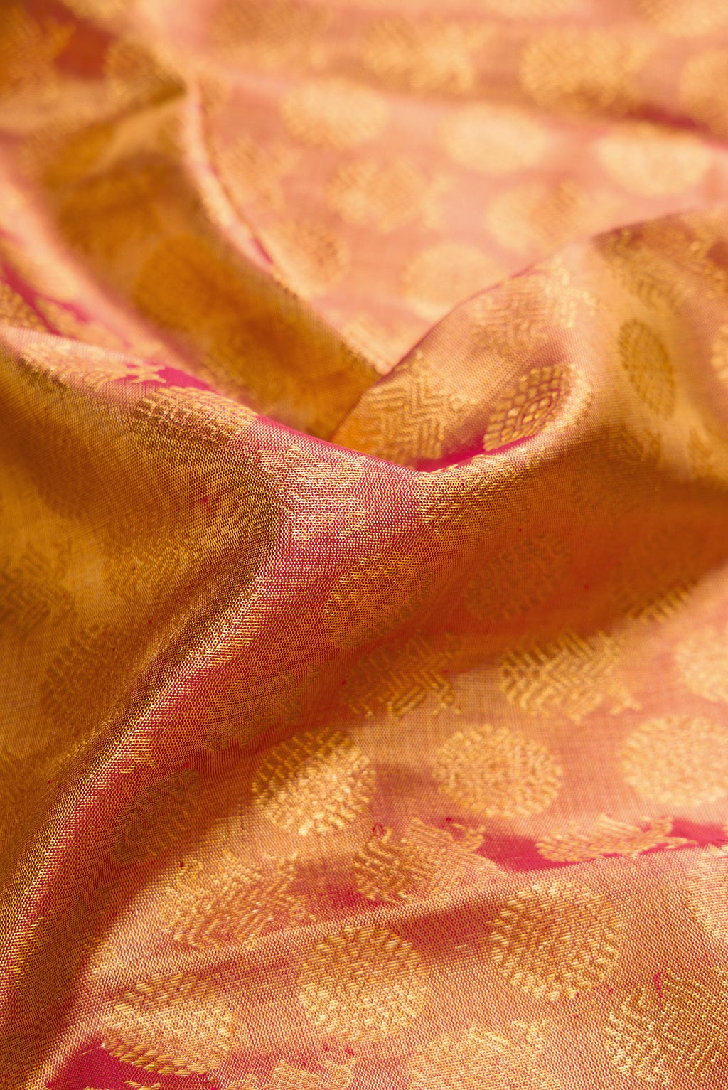 Close up of Dark Pink Dual Tone Kanchipuram Tissue Silk Saree with Zari Brocade on the body and Zari Border.  displaying folds