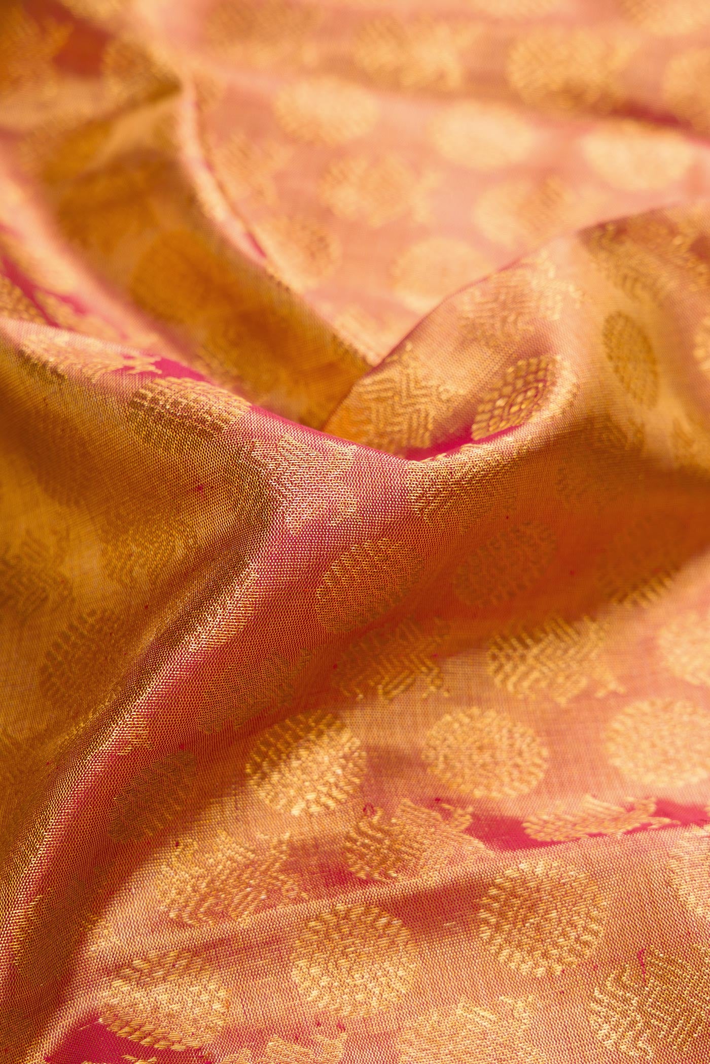 Close up of Dark Pink Dual Tone Kanchipuram Tissue Silk Saree with Zari Brocade on the body and Zari Border.  displaying folds