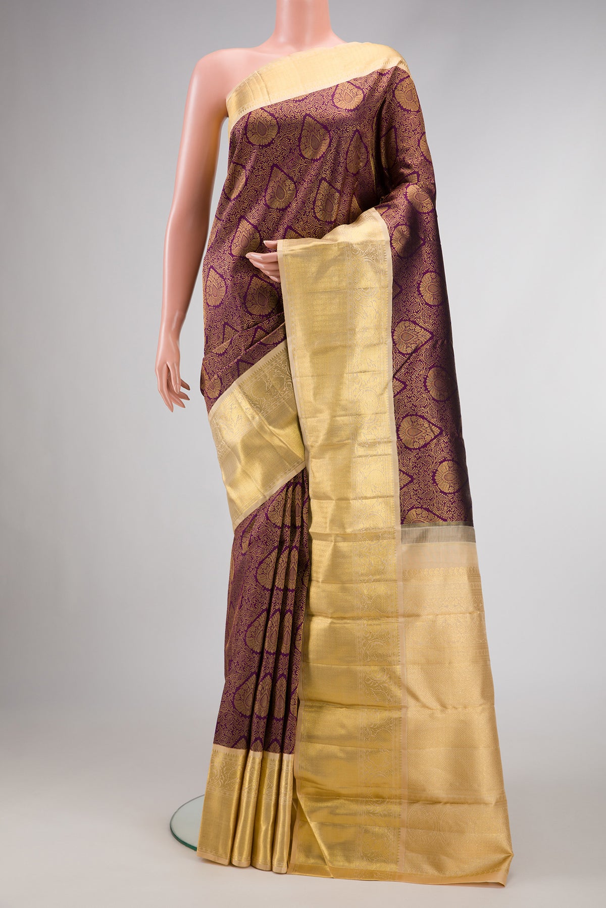 Burgundy Dual Tone Kanjivaram Silk Saree with Zari Brocade on the body and Zari Border.  displayed on a mannequin