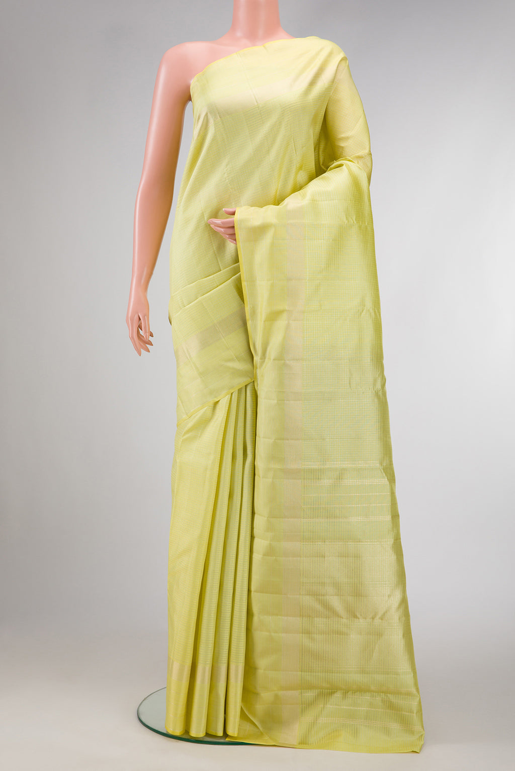 Lemon Yellow Dual Tone Kanchipuram Silk Saree with Checked design on the body and Zari Border.  displayed on a mannequin