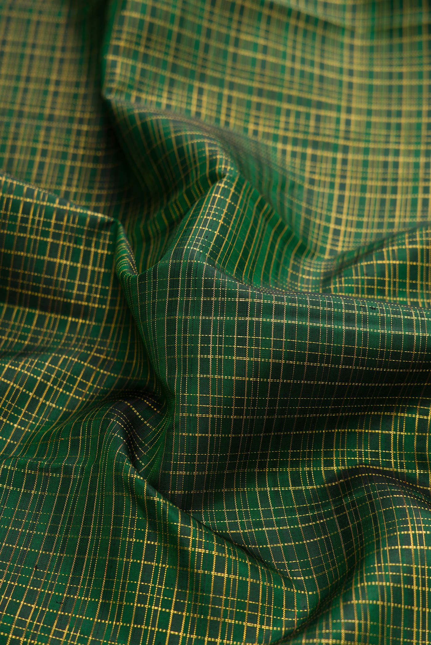 Close up of Bottle Green Dual Tone Kanjivaram Silk Saree with Checked design on the body and Zari Border.  displaying folds