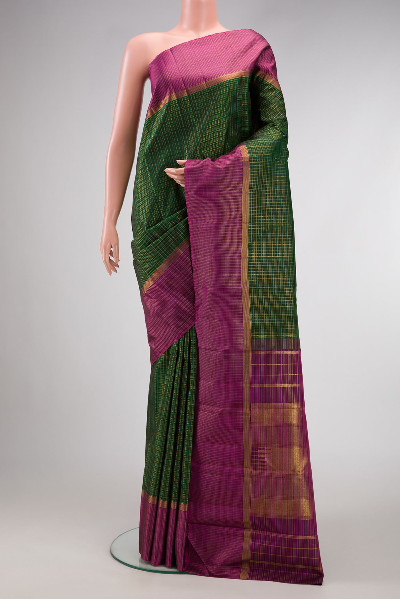 Bottle Green Dual Tone Kanjivaram Silk Saree with Checked design on the body and Zari Border.  displayed on a mannequin