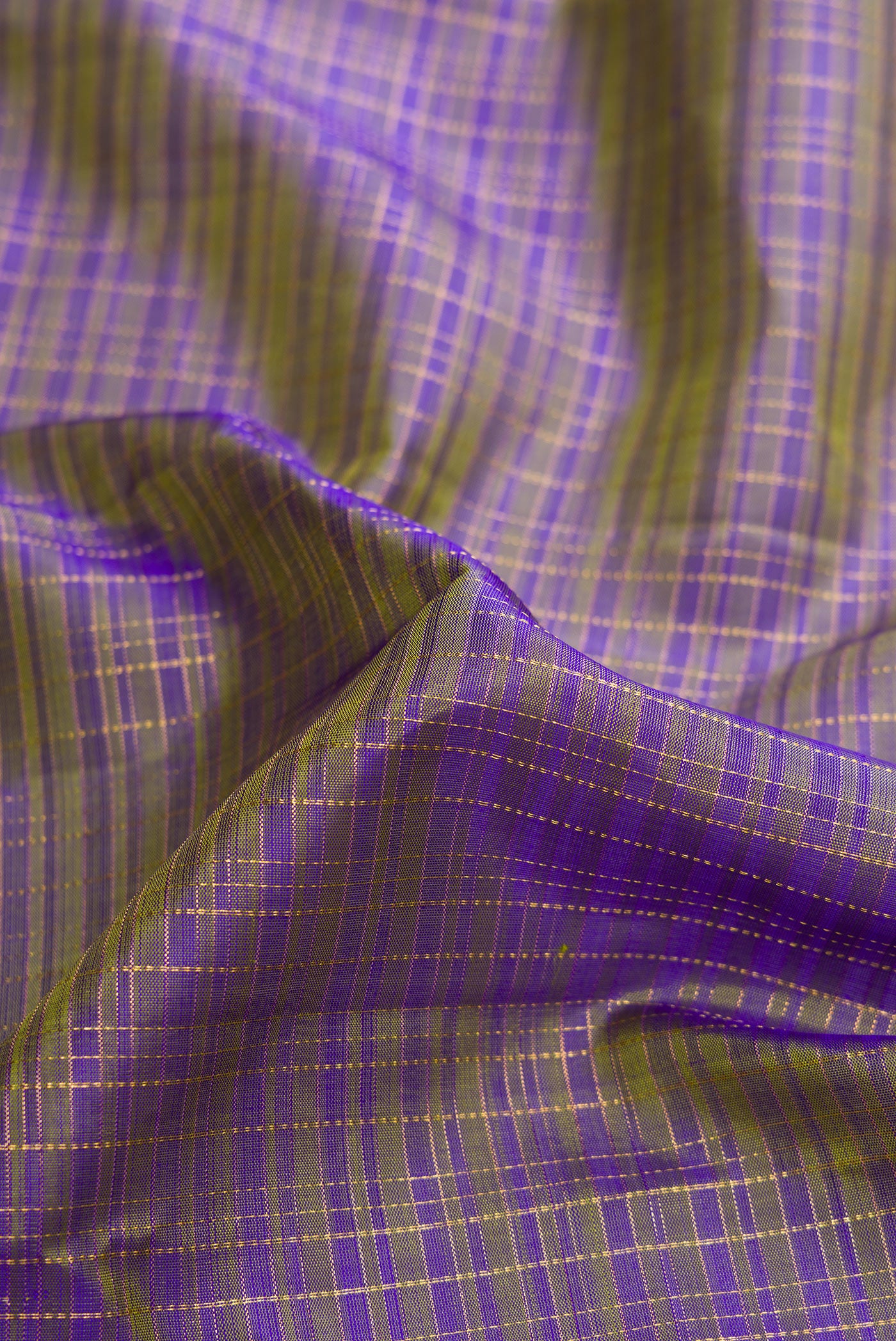 Close up of Blue Dual Tone Kanjivaram Silk Saree with Checked design on the body and Zari Border.  displaying folds