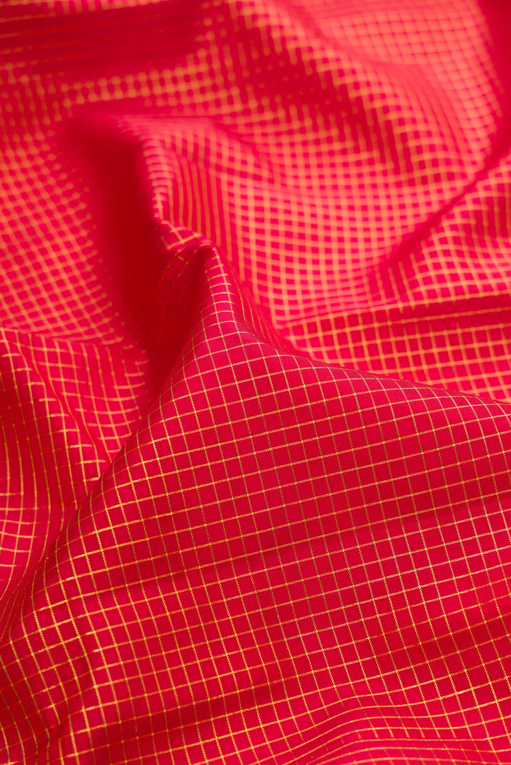 Close up of Pure Silk Deep Red Kanjivaram Saree with Checked design on the body and Zari Border.  displaying folds