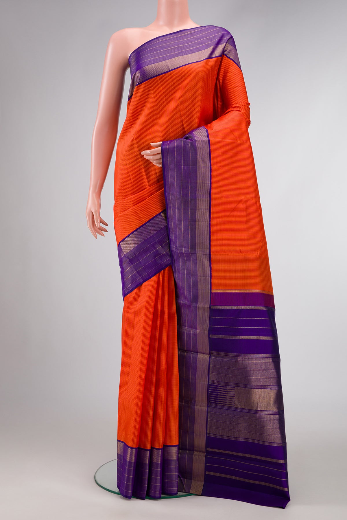 Pure Silk Pure Zari Orange Dual Tone Kanjivaram Saree with Checked design on the body and Zari Border.  displayed on a mannequin