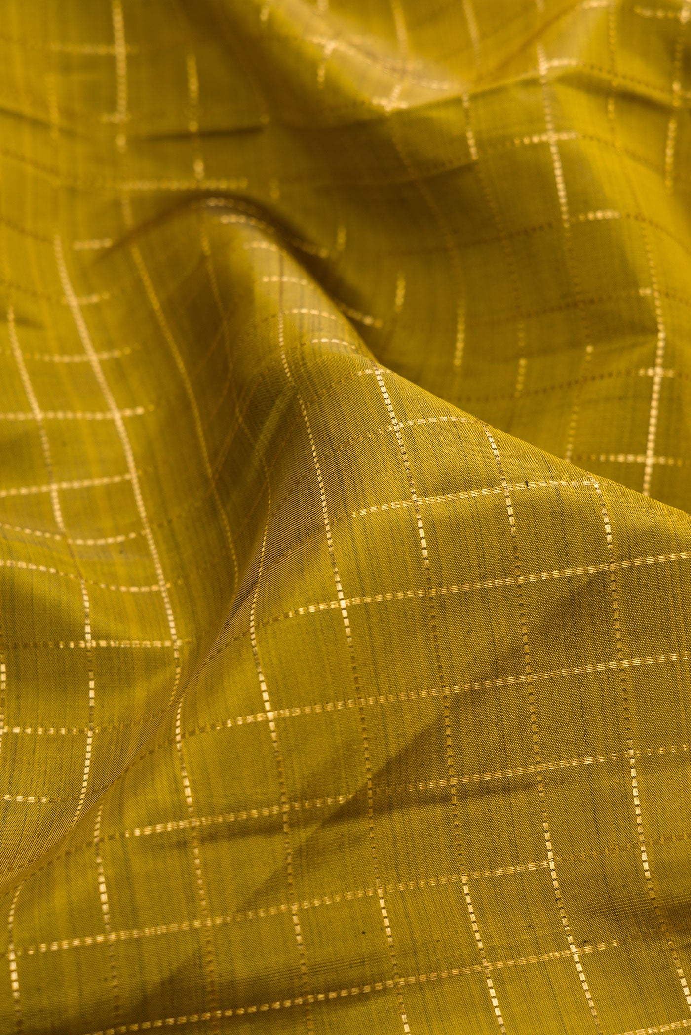 Close up of Mehandi Green Dual Tone Kanjivaram Silk Saree with Checked design on the body and Zari Border.  displaying folds