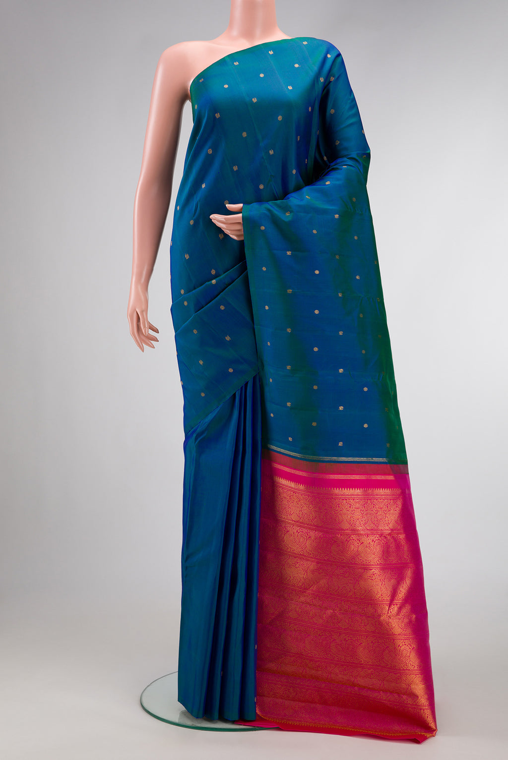 Peacock Blue Dual Tone Kanjivaram Silk Saree with Zari Butta on the body and Without Border.  displayed on a mannequin