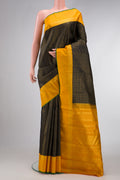 Black Dual Tone Kanjivaram Silk Saree with Checked design on the body and Zari Border.  displayed on a mannequin