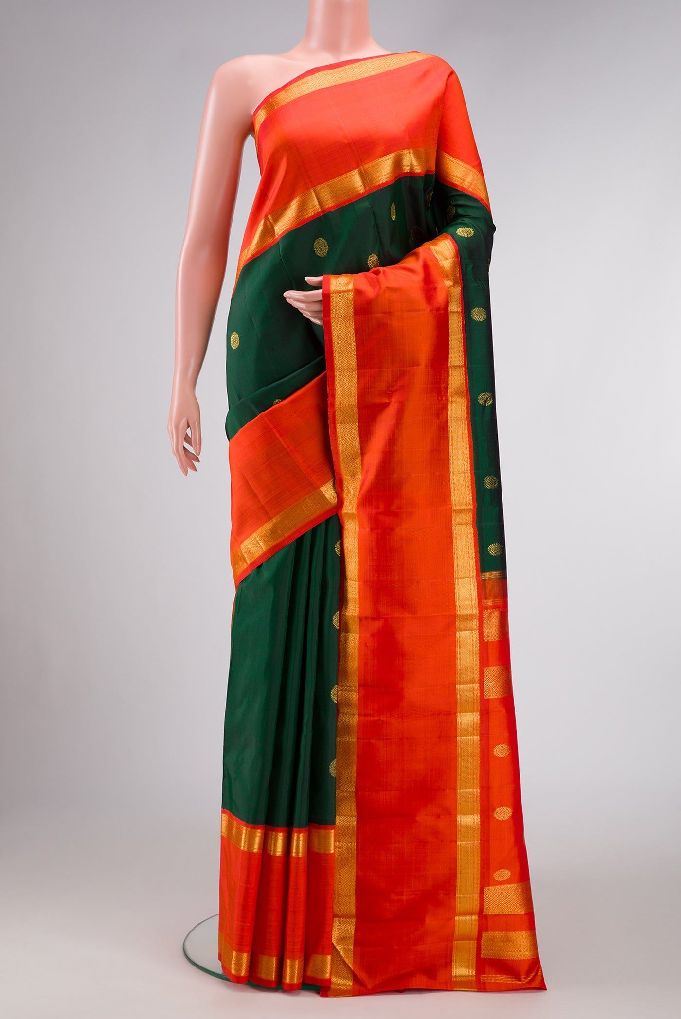 Bottle Green Dual Tone Kanchipuram Silk Saree with Zari Butta on the body and Zari Border.  displayed on a mannequin