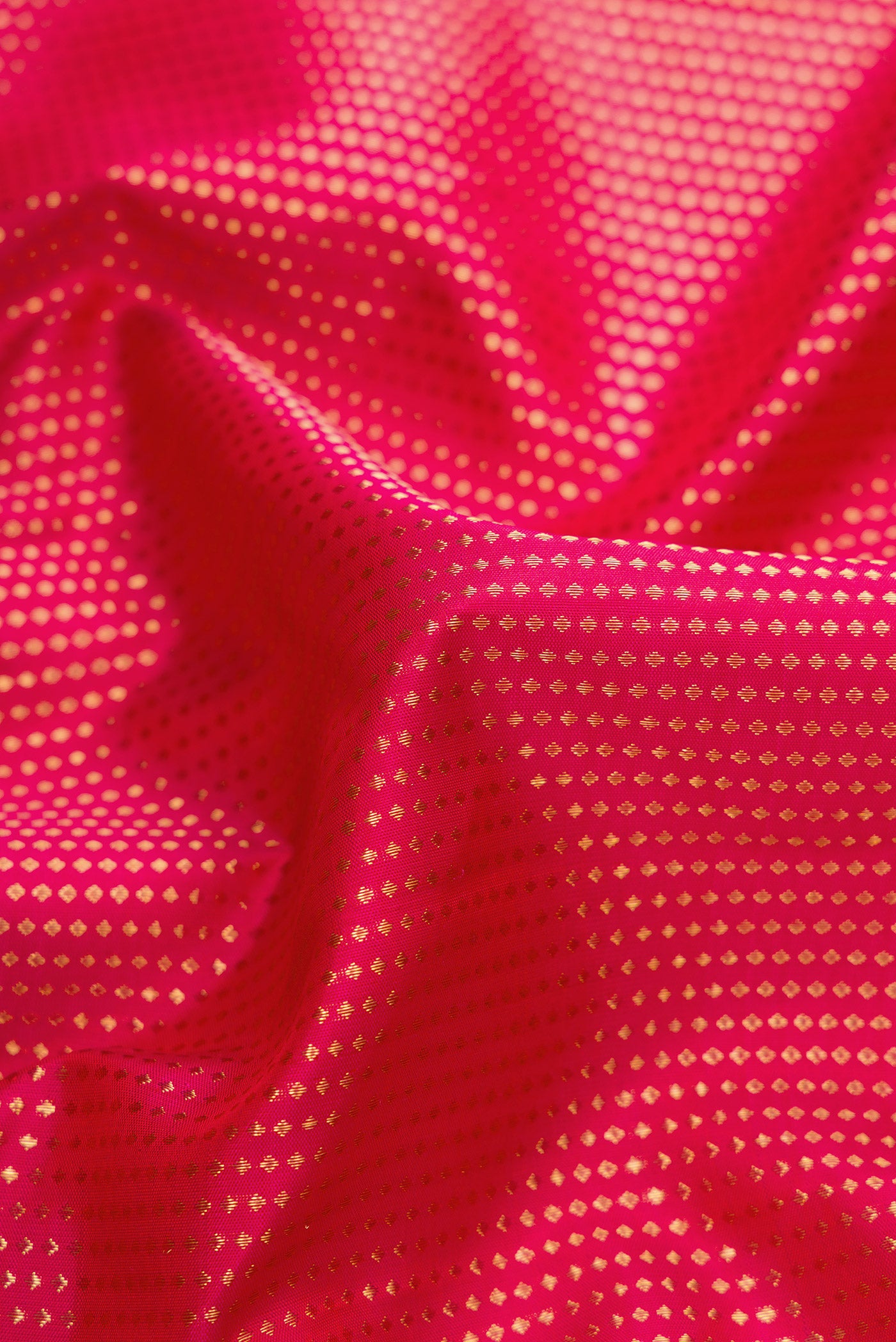 Close up of Dark Pink Dual Tone Kanchipuram Silk Saree with Zari Brocade on the body and Zari Border.  displaying folds