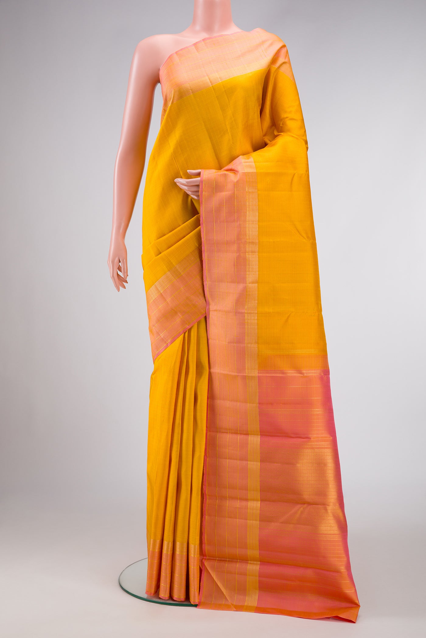 Yellow Dual Tone Kanjivaram Silk Saree with Checked design on the body and Zari Border.  displayed on a mannequin