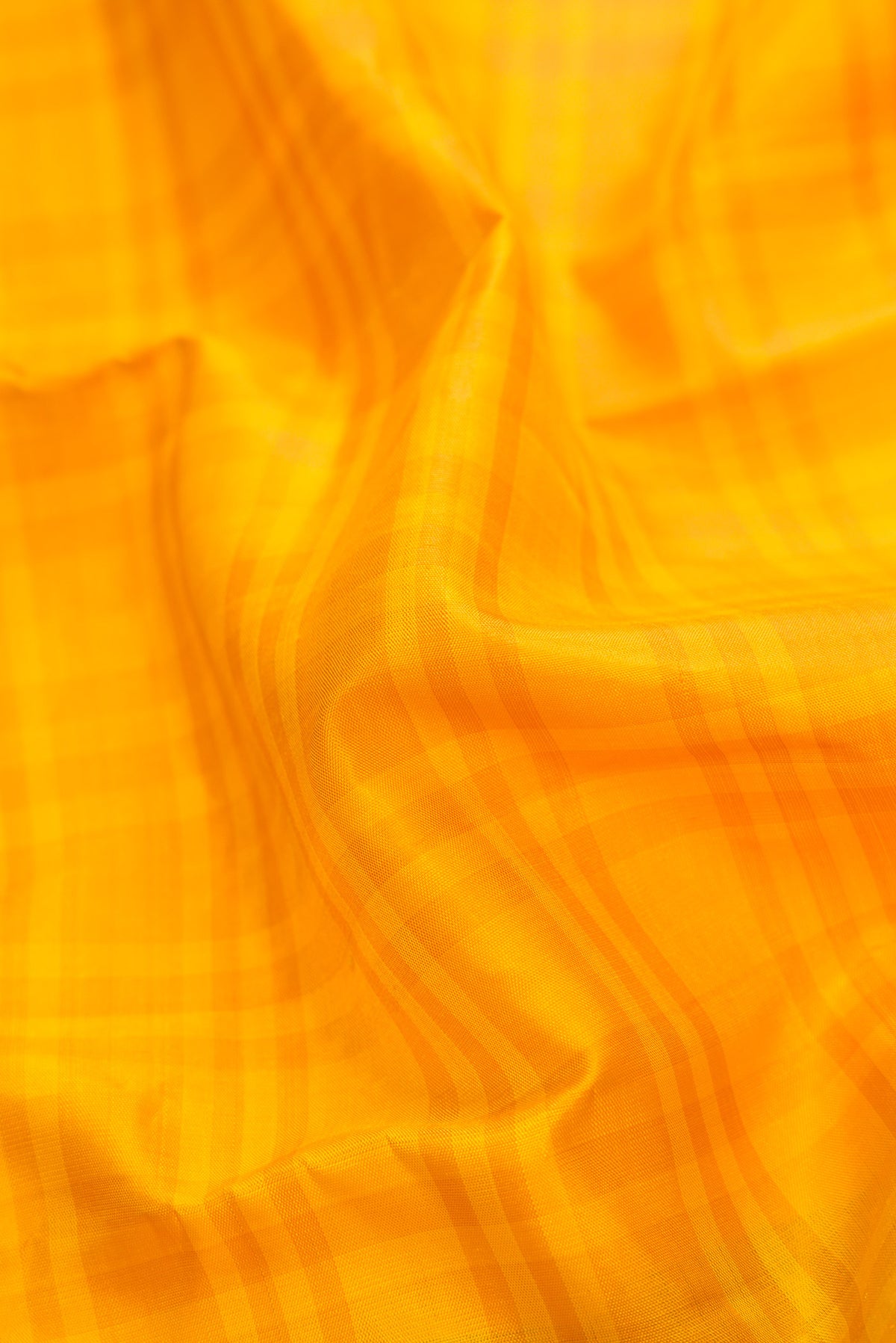 Close up of Yellow Dual Tone Kanjivaram Silk Saree with Stripes on the body and Zari Border.  displaying folds