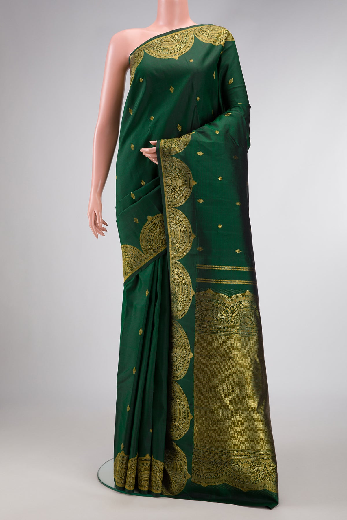 Green Dual Tone Kanjivaram Silk Saree with Zari Butta on the body and Fancy Border.  displayed on a mannequin