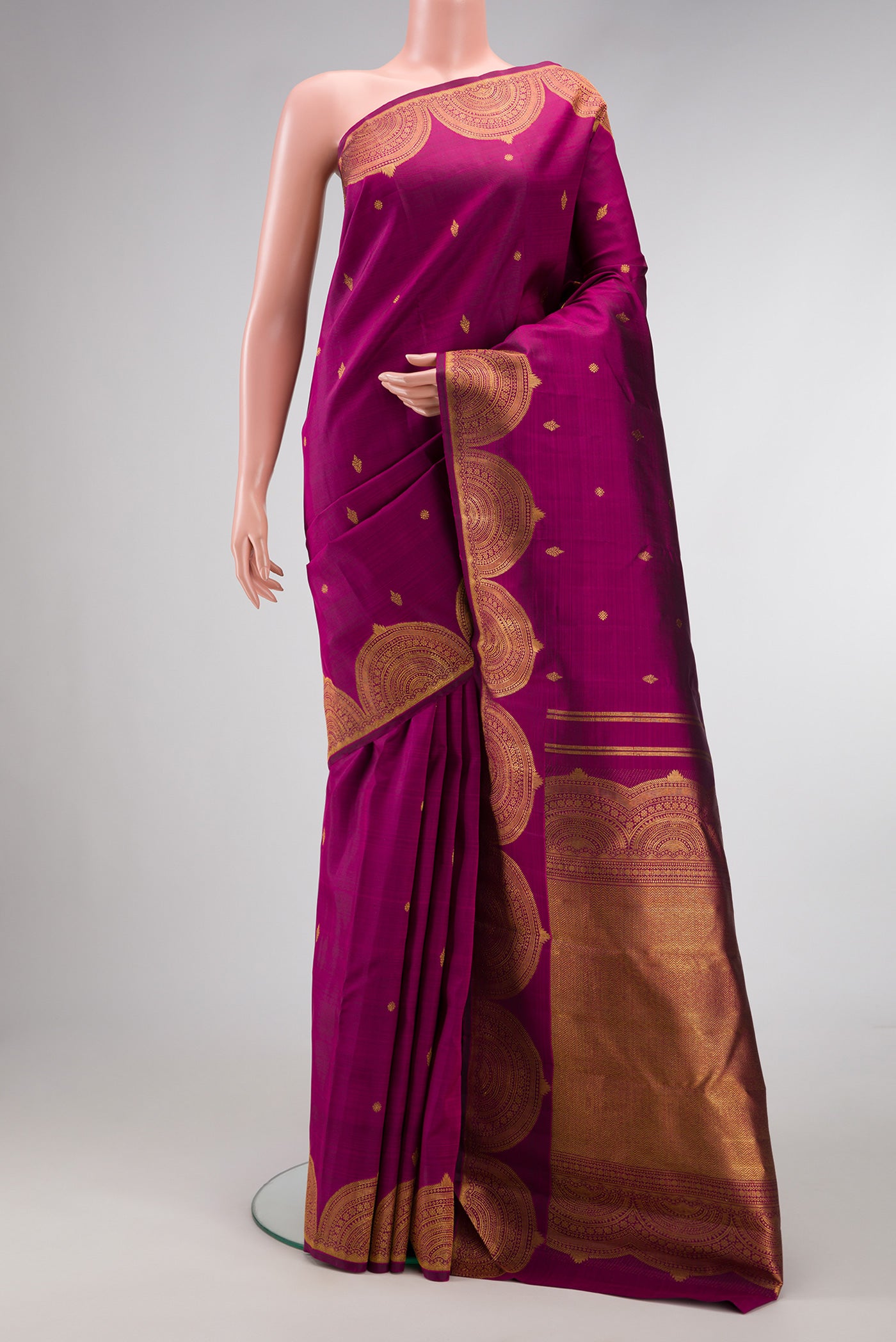Magenta Dual Tone Kanjivaram Silk Saree with Zari Butta on the body and Fancy Border.  displayed on a mannequin