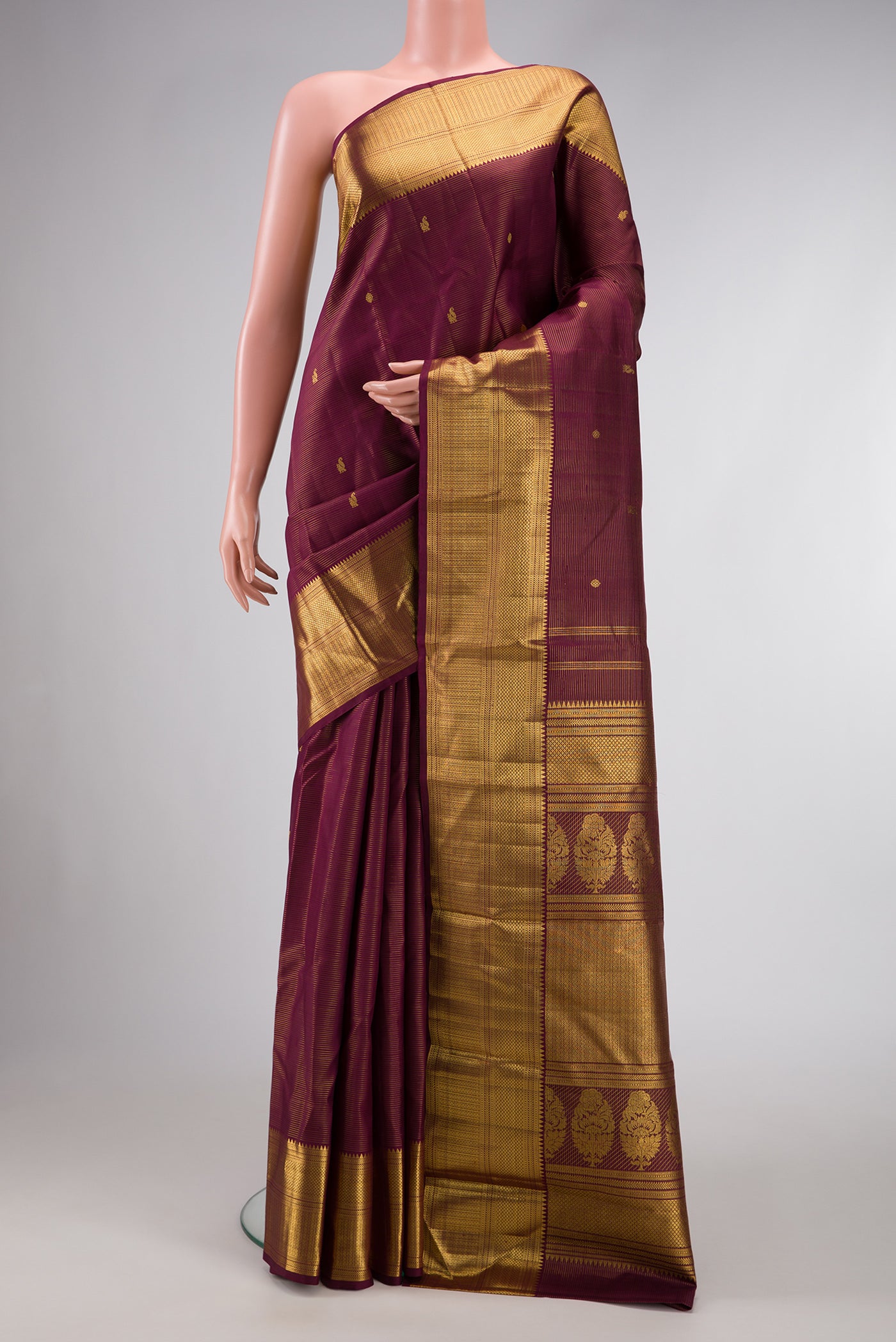 Burgundy Dual Tone Kanjivaram Silk Saree with Stripes on the body and Zari Border.  displayed on a mannequin