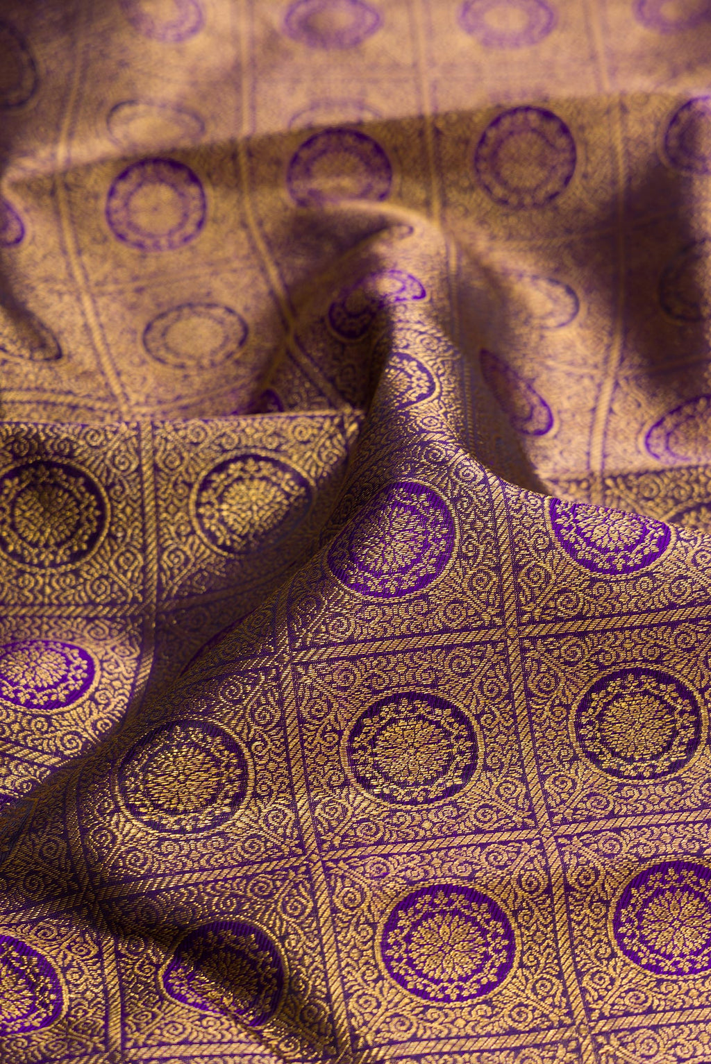 Close up of Violet Dual Tone Kanchipuram Silk Saree with Zari Brocade on the body and Zari Border.  displaying folds