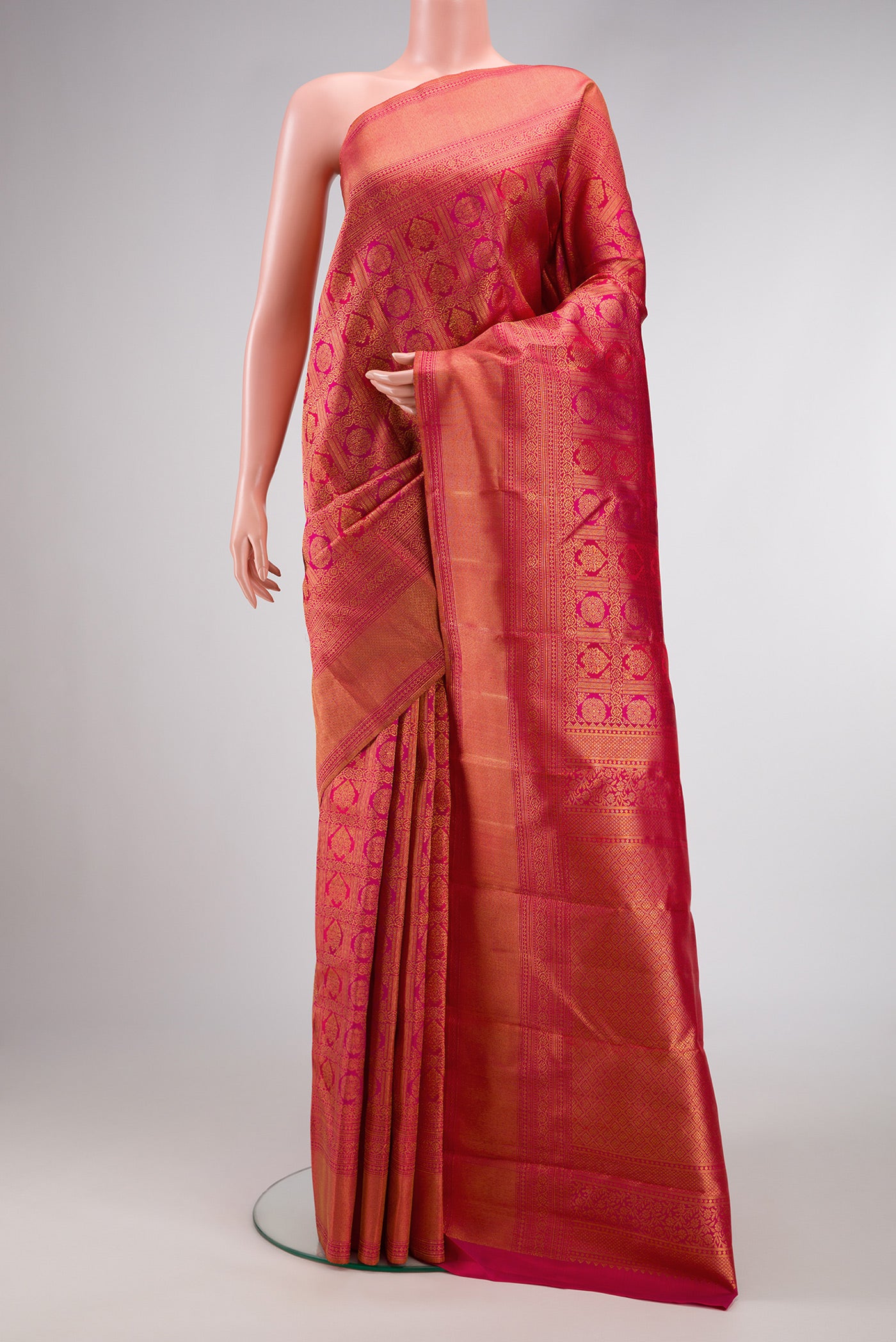 Dark Pink Dual Tone Kanchipuram Silk Saree with Zari Brocade on the body and Zari Border.  displayed on a mannequin