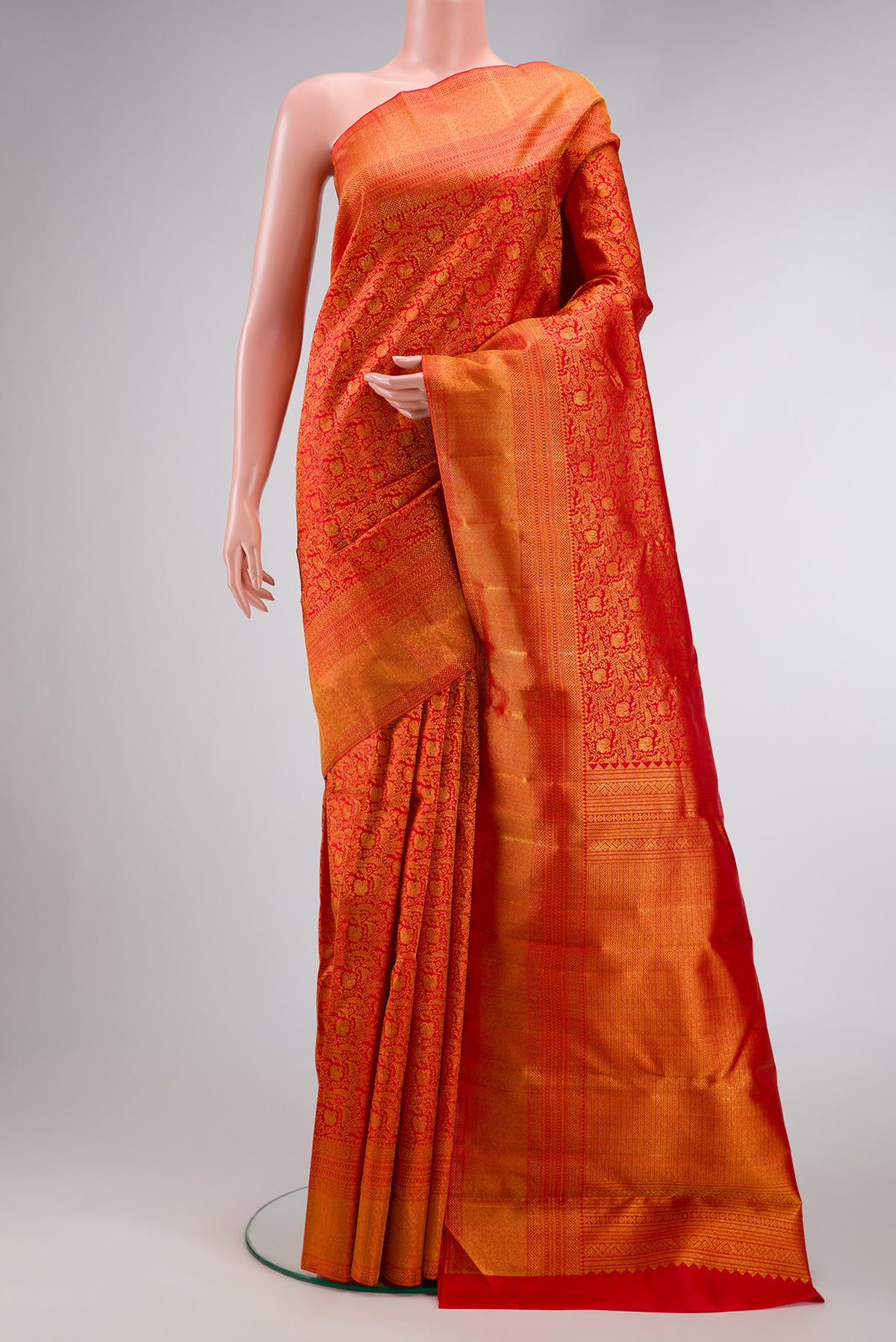 Red Dual Tone Kanchipuram Silk Saree with Zari Brocade on the body and Zari Border.  displayed on a mannequin