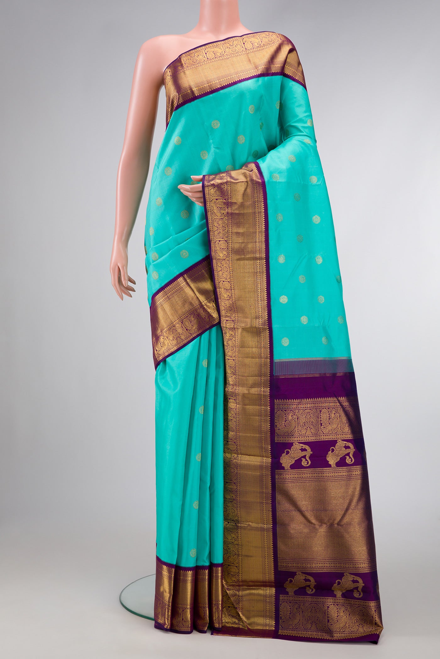 Sky Blue Dual Tone Kanchipuram Silk Saree with Zari Butta on the body and Zari Border.  displayed on a mannequin