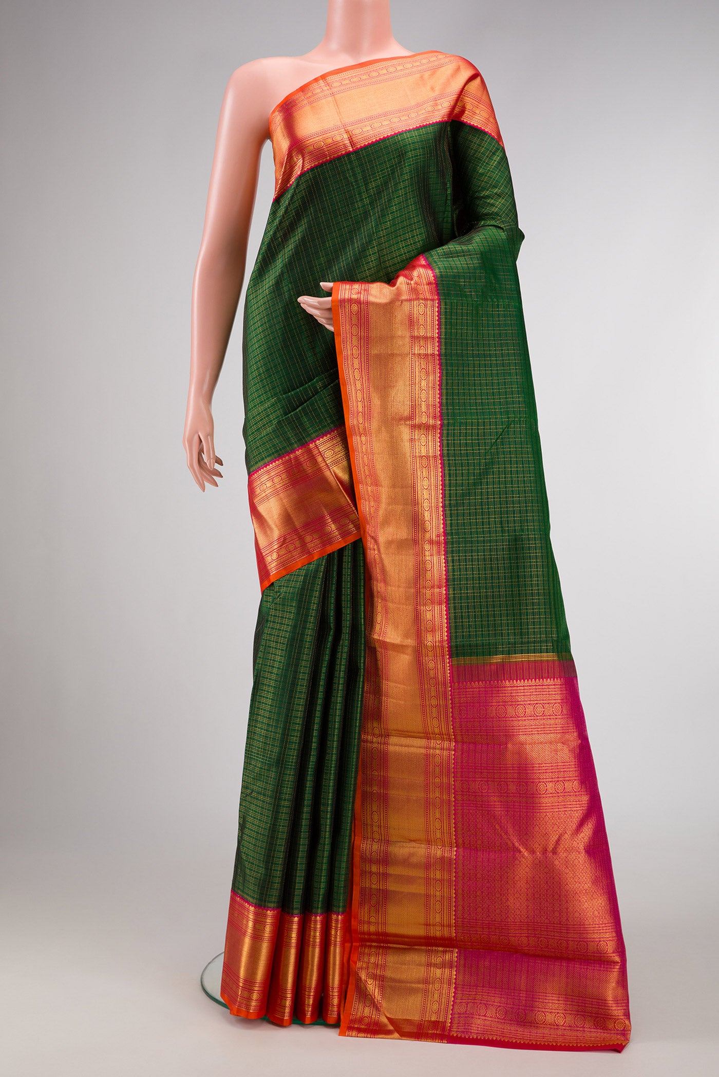 Bottle Green Dual Tone Kanchipuram Silk Saree with Checked design on the body and Zari Border.  displayed on a mannequin