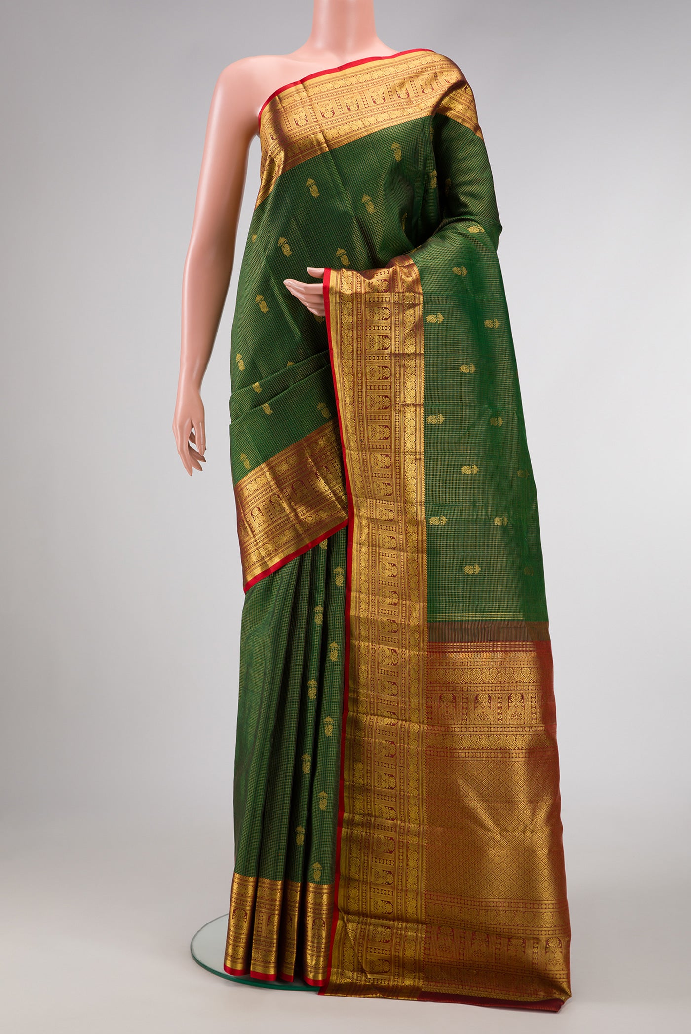 Bottle Green Dual Tone Kanchipuram Silk Saree with Checked design on the body and Zari Border.  displayed on a mannequin