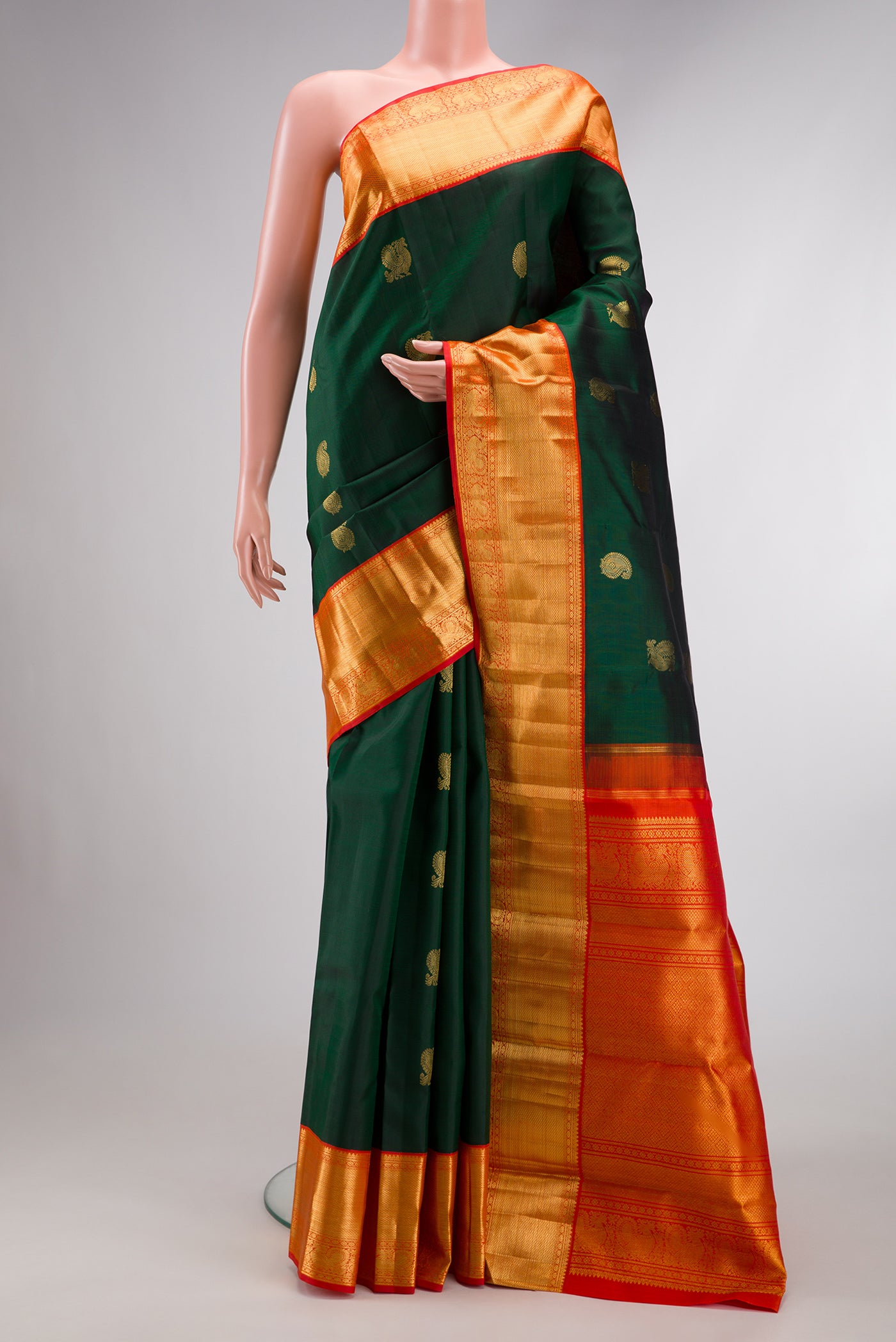 Green Dual Tone Kanchipuram Silk Saree with Zari Butta on the body and Zari Border.  displayed on a mannequin