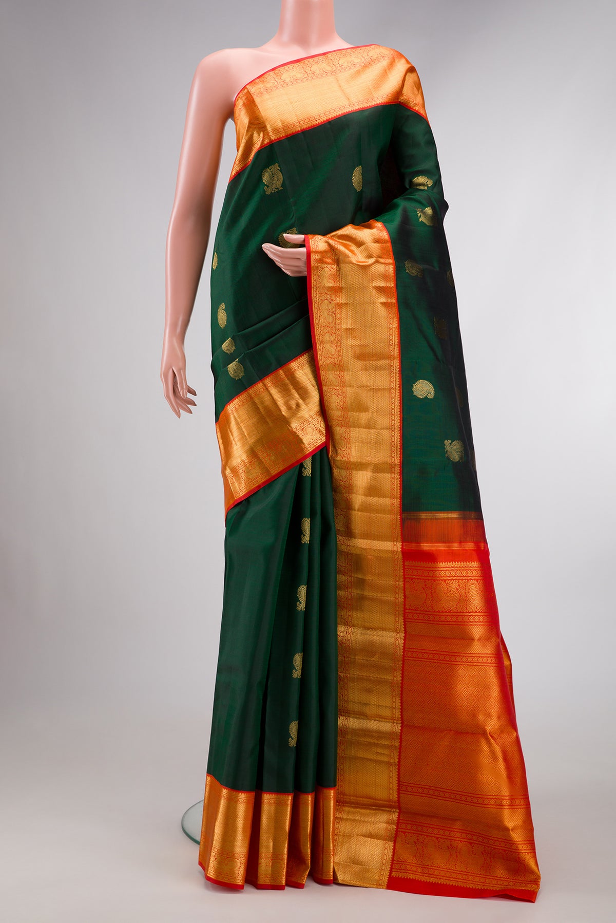Green Dual Tone Kanchipuram Silk Saree with Zari Butta on the body and Zari Border.  displayed on a mannequin