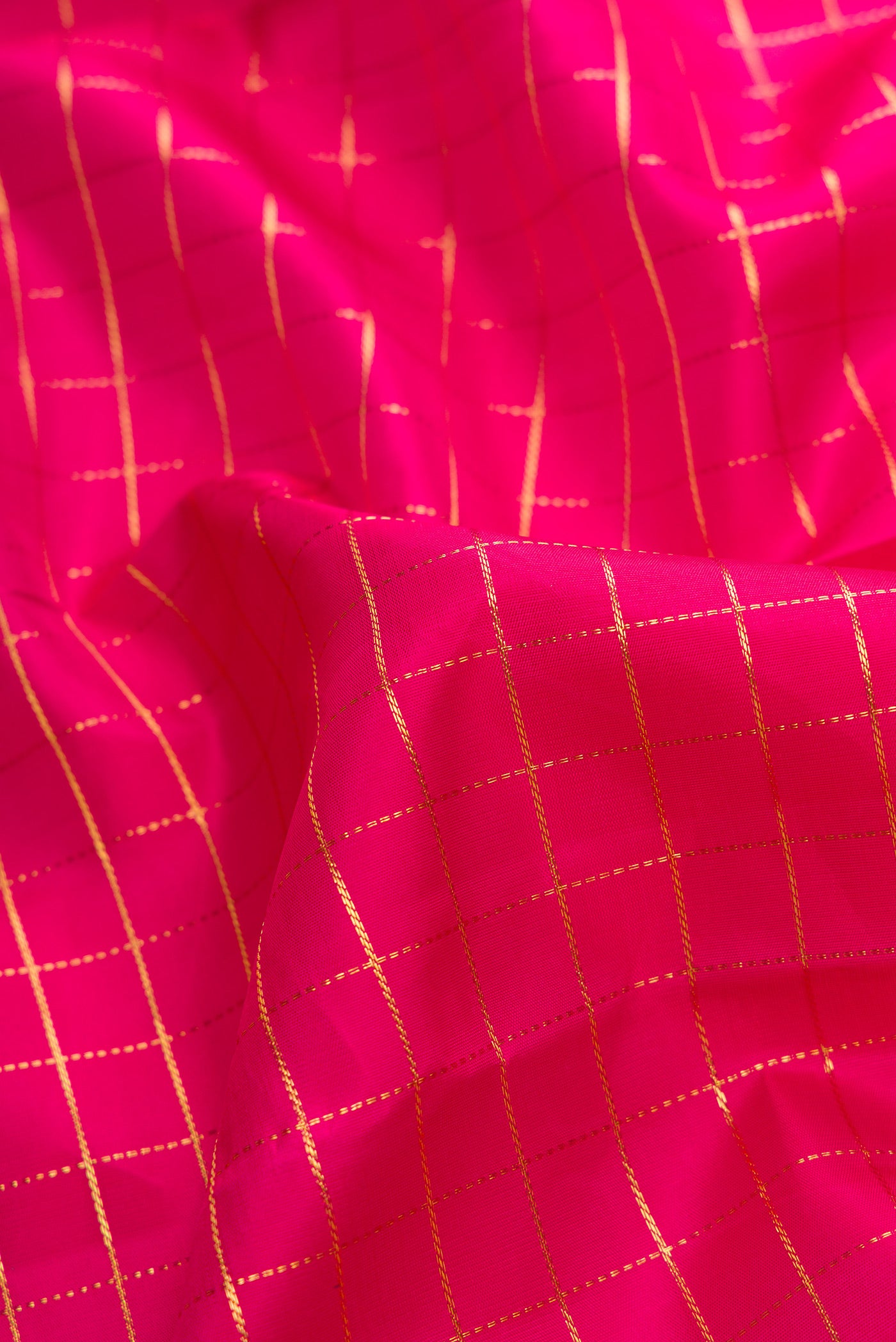 Close up of Pink Dual Tone Kanchipuram Silk Saree with Zari Butta on the body and Zari Border.  displaying folds