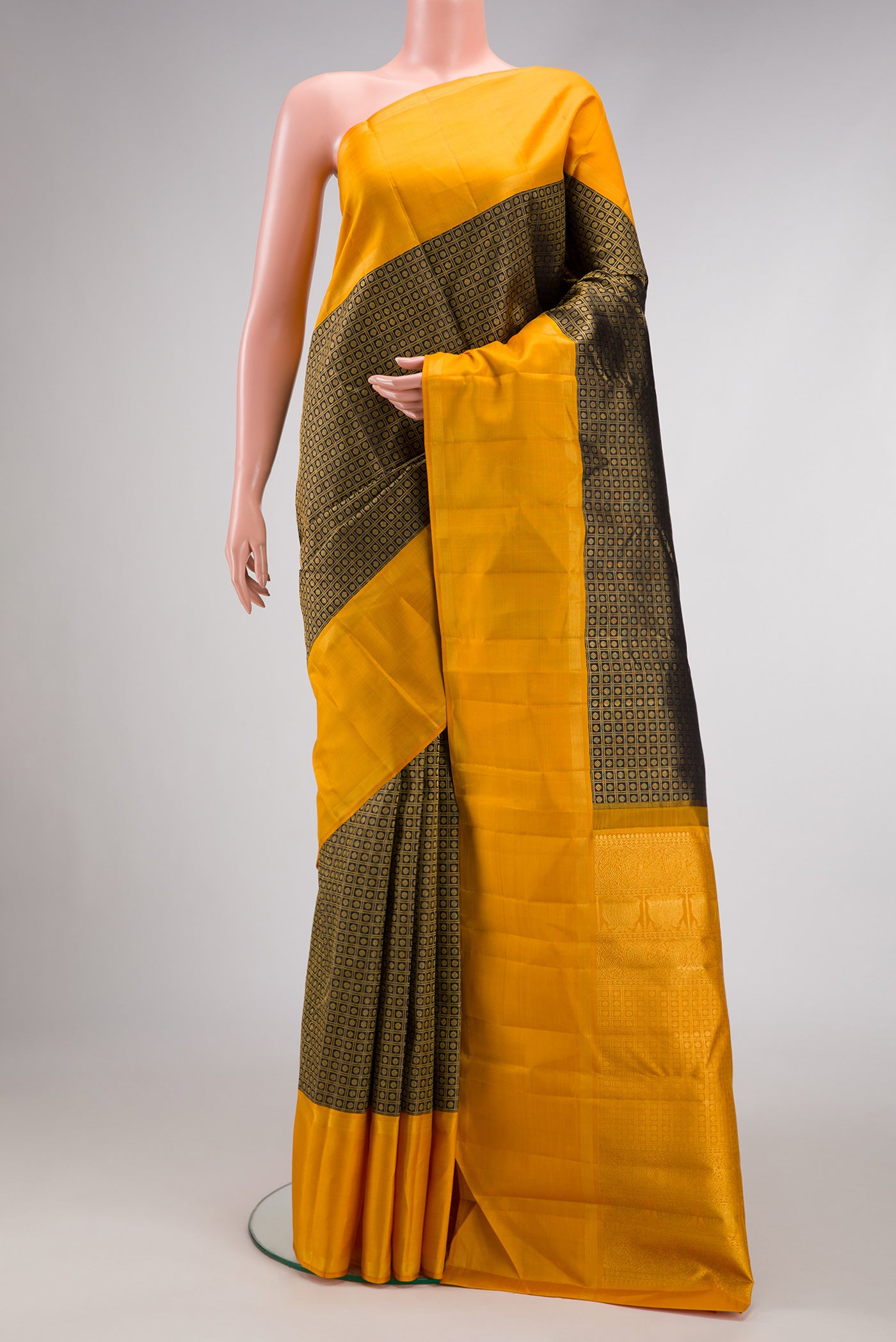 Black Dual Tone Kanchipuram Silk Saree with Zari Brocade on the body and Zari Border.  displayed on a mannequin