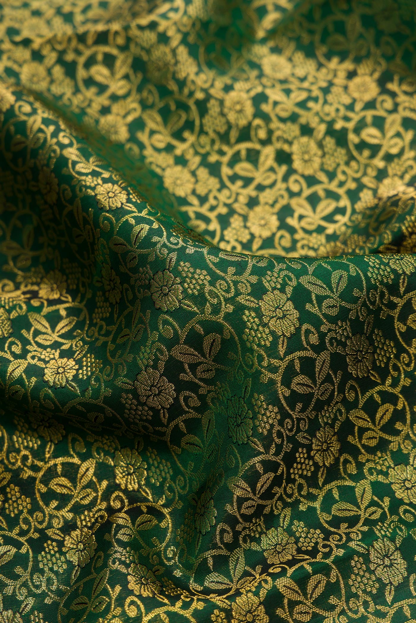 Close up of Bottle Green Dual Tone Kanchipuram Silk Saree with Zari Brocade on the body and Fancy Border.  displaying folds