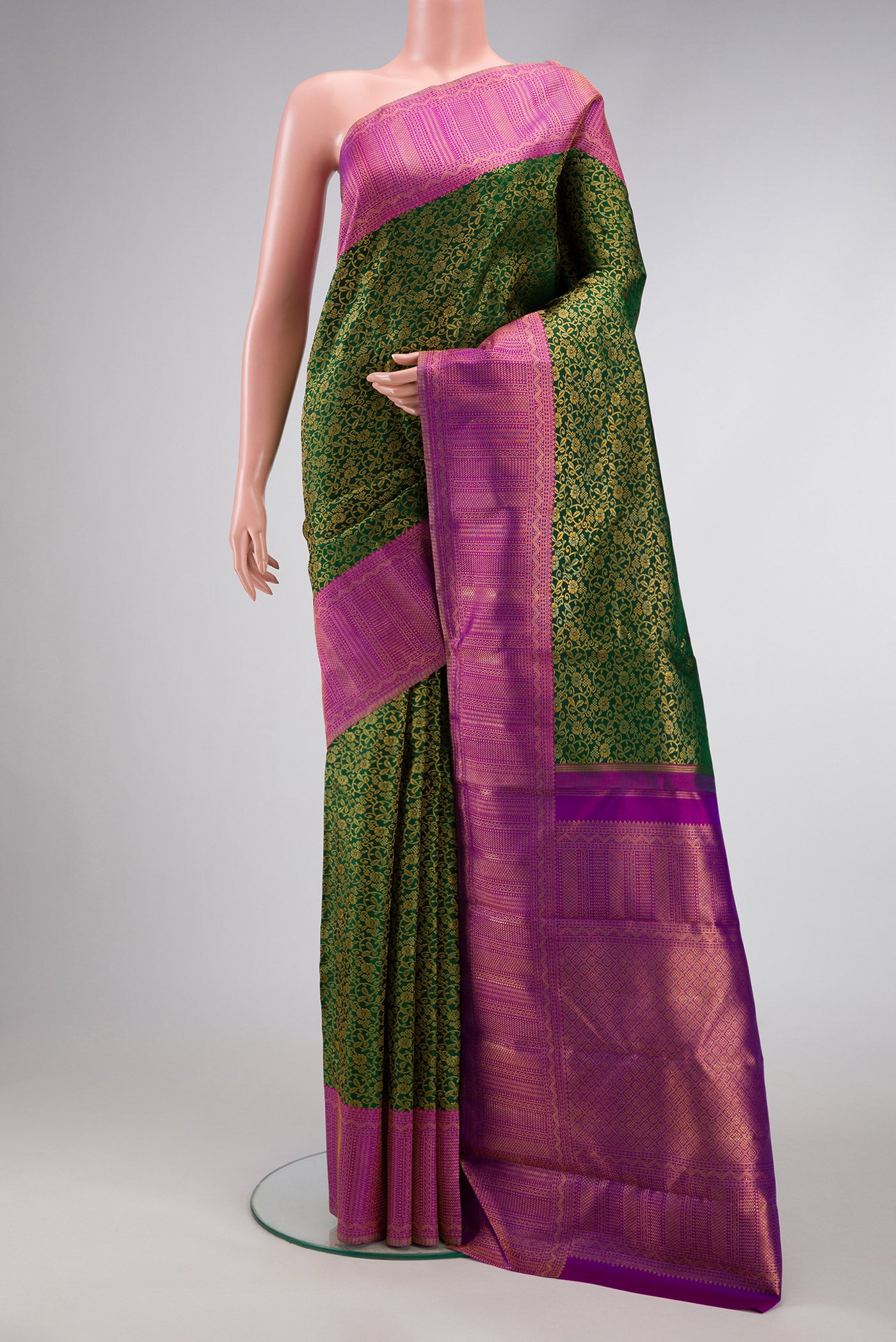 Bottle Green Dual Tone Kanchipuram Silk Saree with Zari Brocade on the body and Fancy Border.  displayed on a mannequin